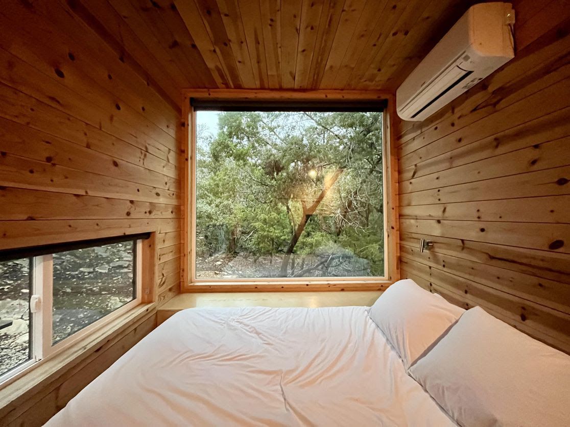 a photo of a bed with a window in the background