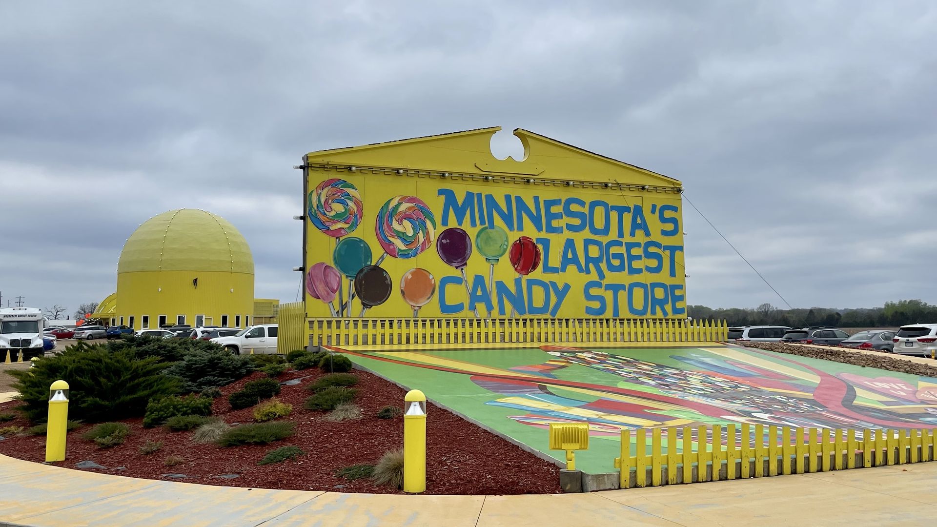 The exterior of Minnesota's Largest Candy Store, a bright yellow barn.