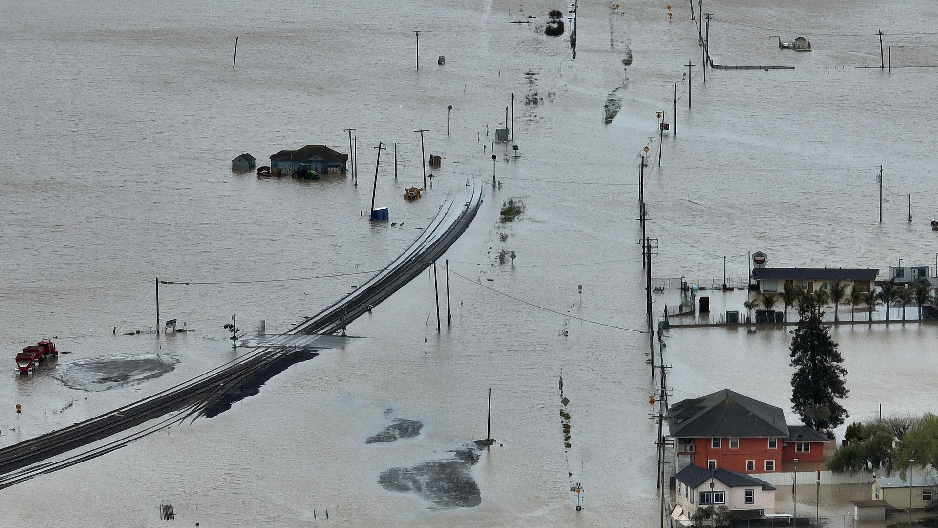 Picture of flooding inundating a road and homes in California.