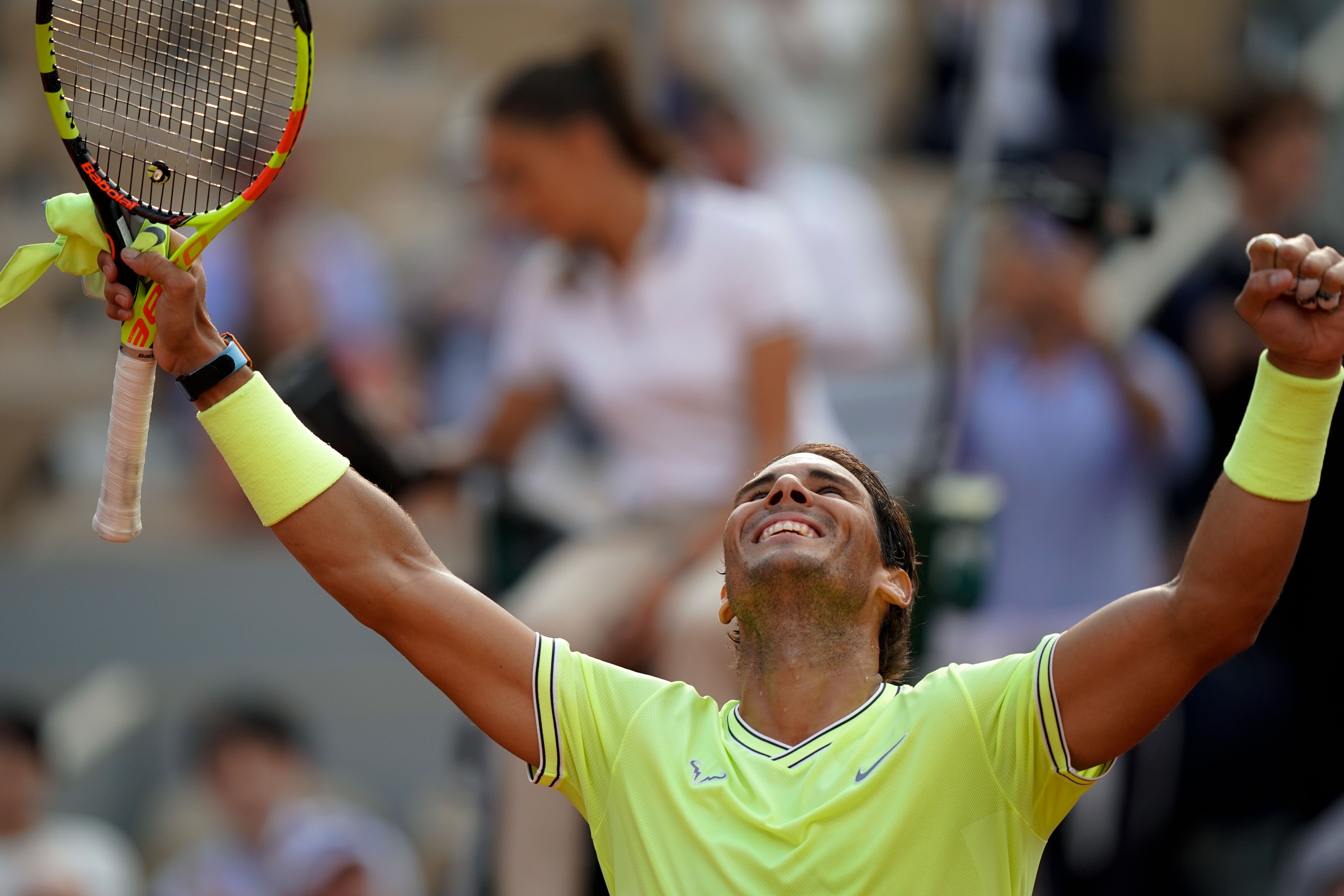 Rafael Nadal with his arms raised in the air