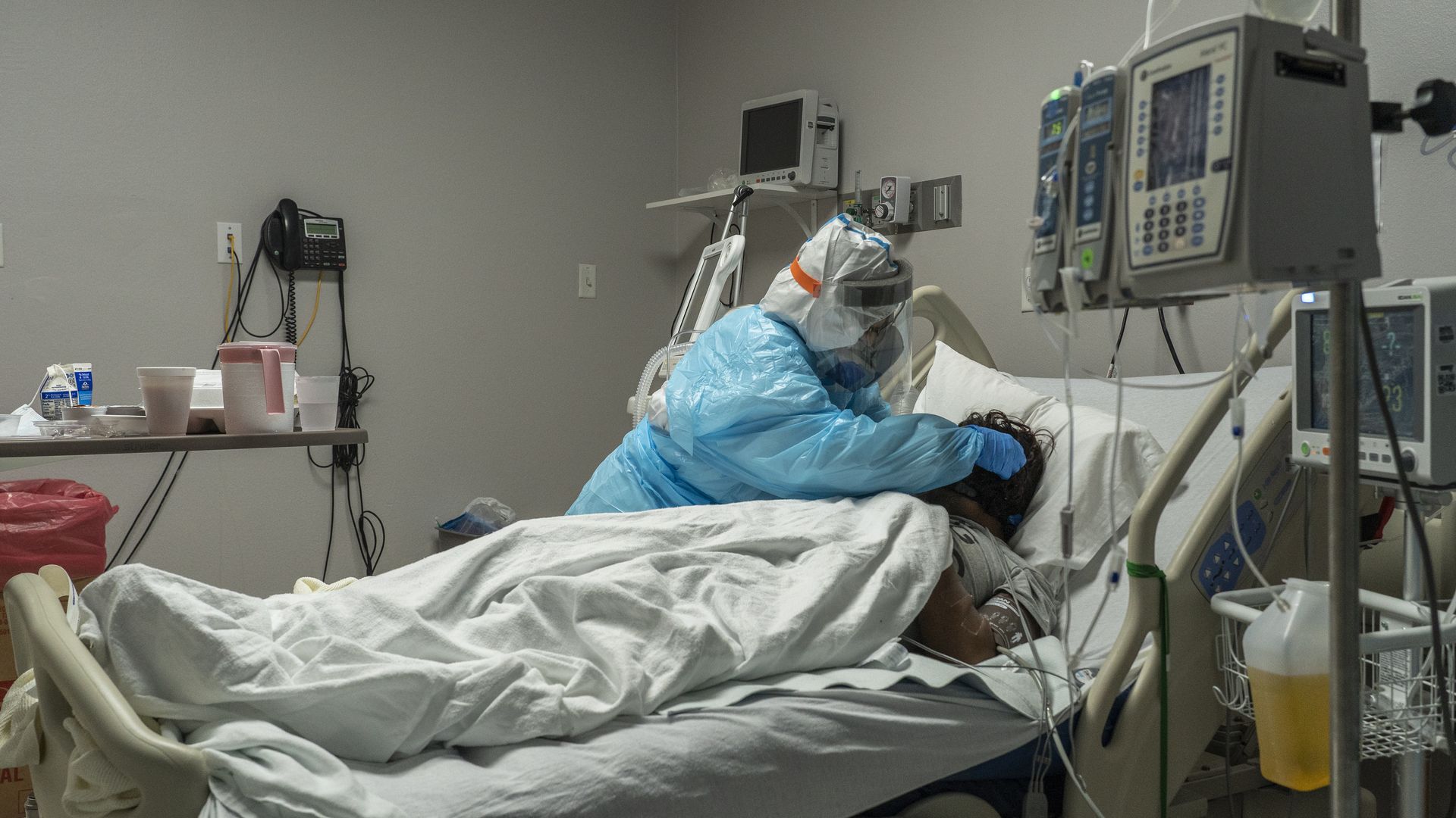 A medical staff member tends to a patient at a Texas hospital.