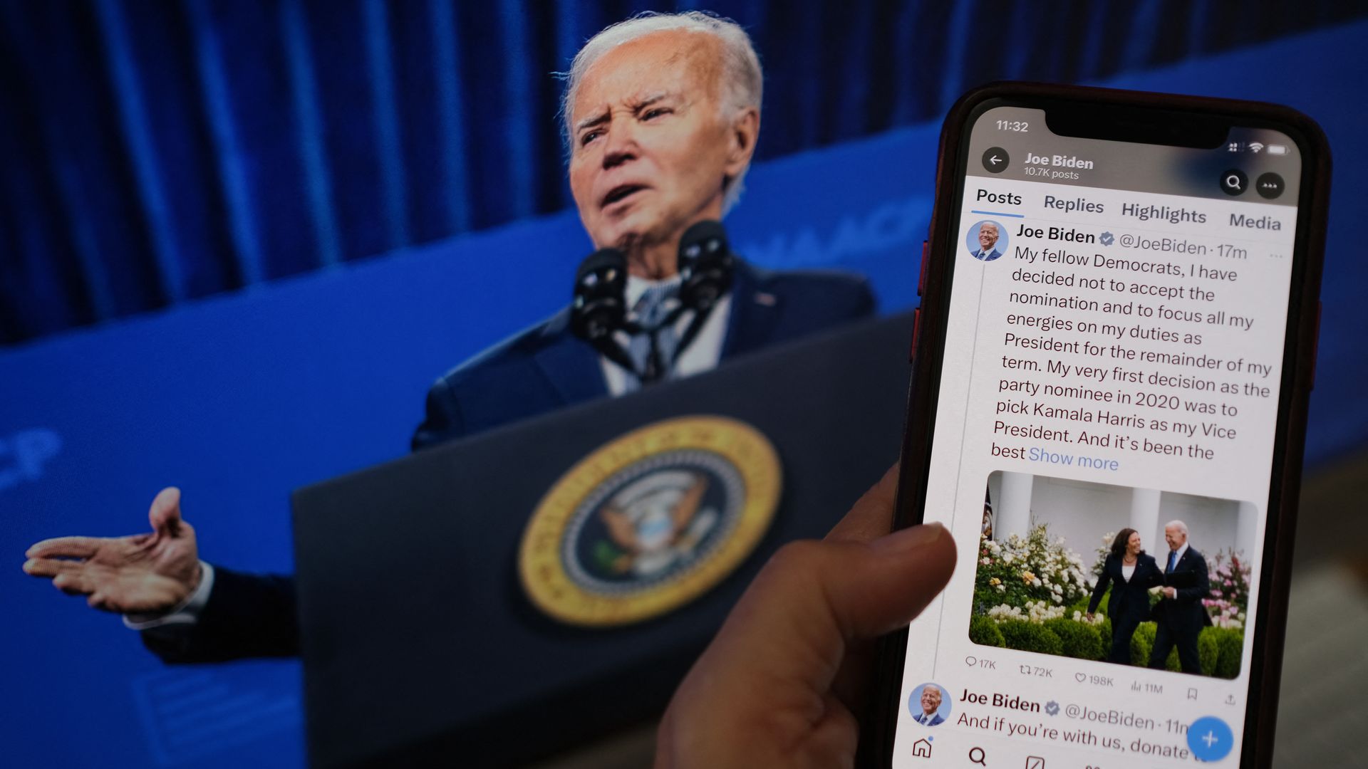 Phone with President Biden's statement on X held up in front of a TV screen with Biden talking