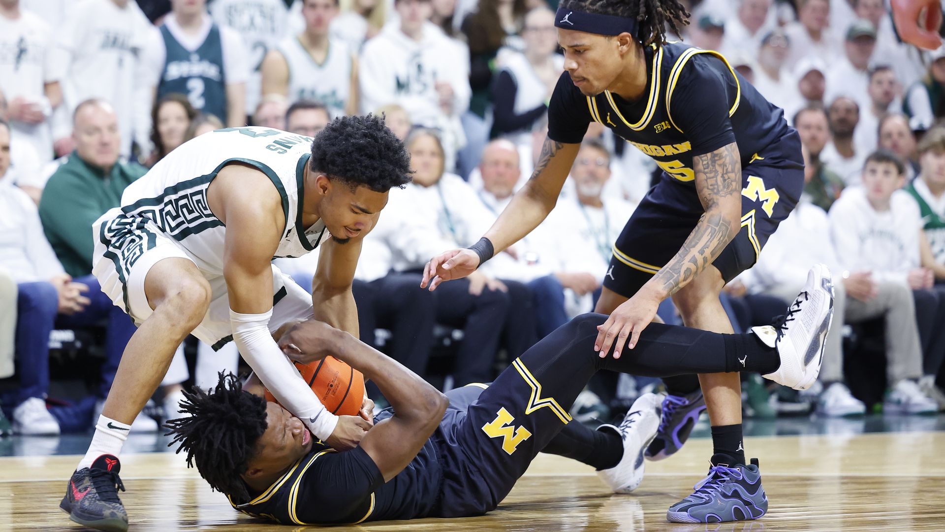 MSU's Jaden Akins battles for a loose ball against U of M on March 9. 