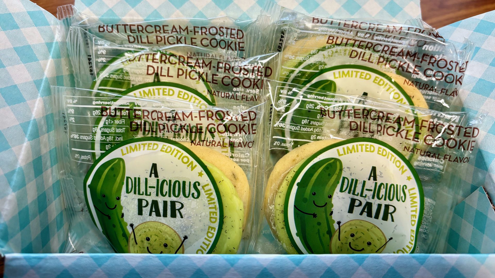 A box of Cheryl's pickle cookies, in packaging that says "a dill-icious pair" with a cartoon pickle on it