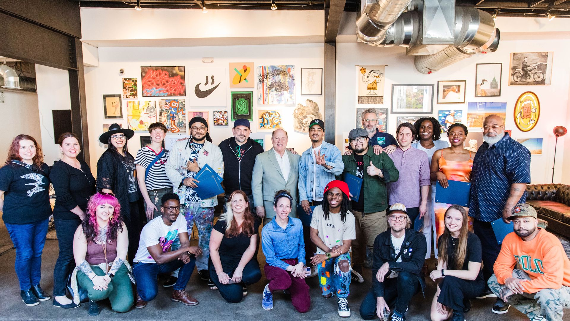 Mayor Mike Duggan poses with City Walls mural artists.