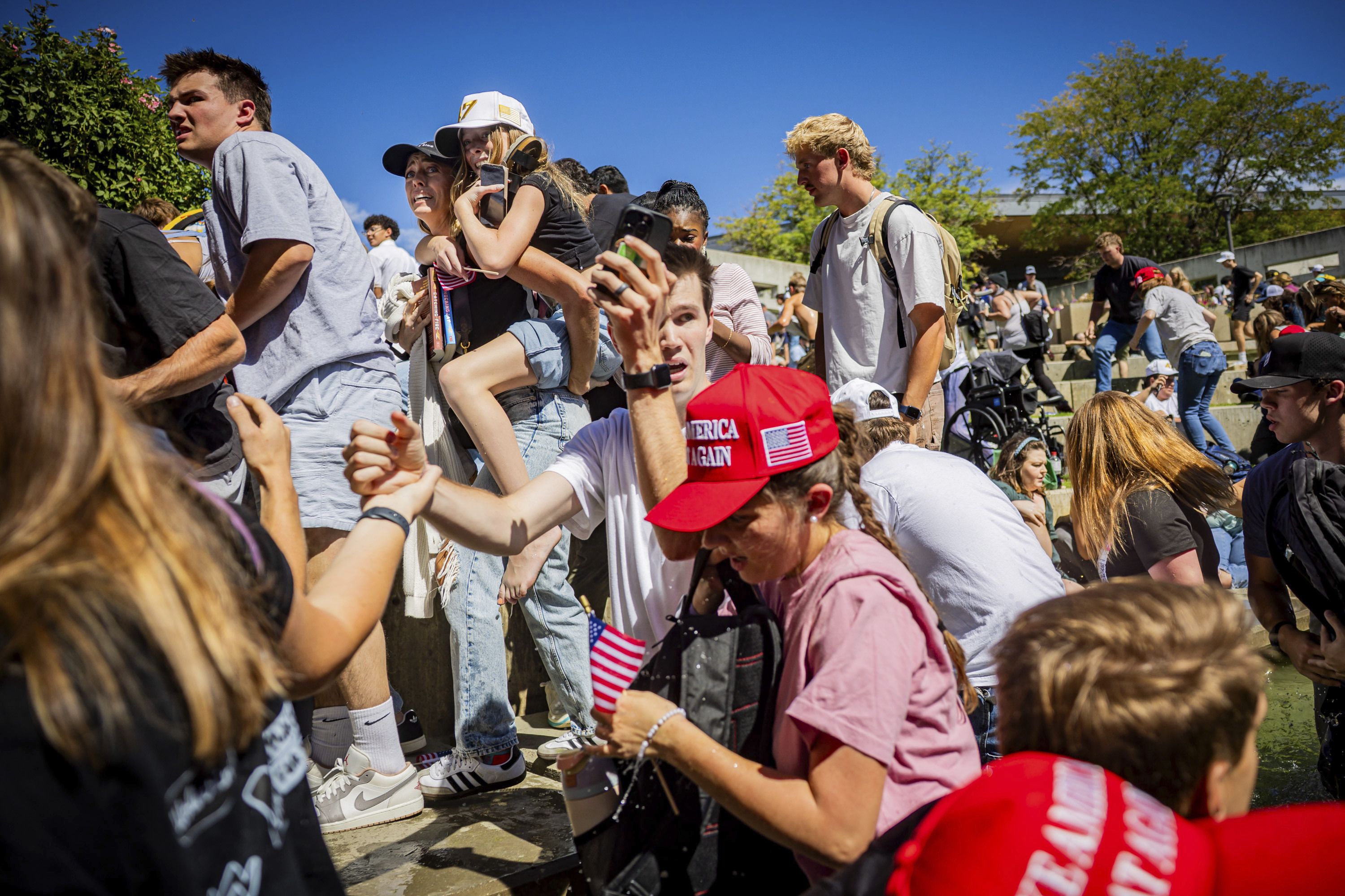 The crowd reacts after Charlie Kirk was shot yesterday at Utah Valley University.