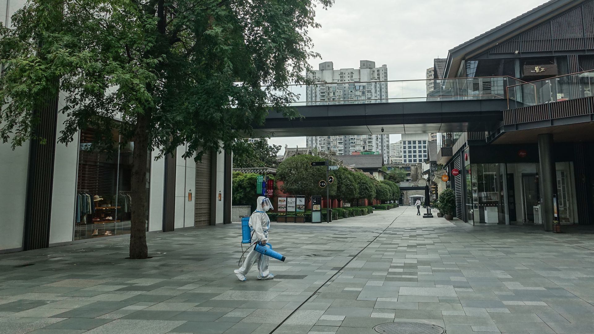 A volunteer disinfects a street in Chengdu, Sichuan Province, China, Sept 3, 2022. The city of Chengdu is temporarily closed because of the virus. 