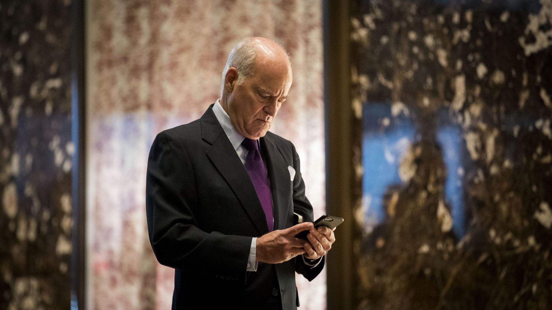KKR co-founder Henry Kravis, looks at phone while at Trump Tower.