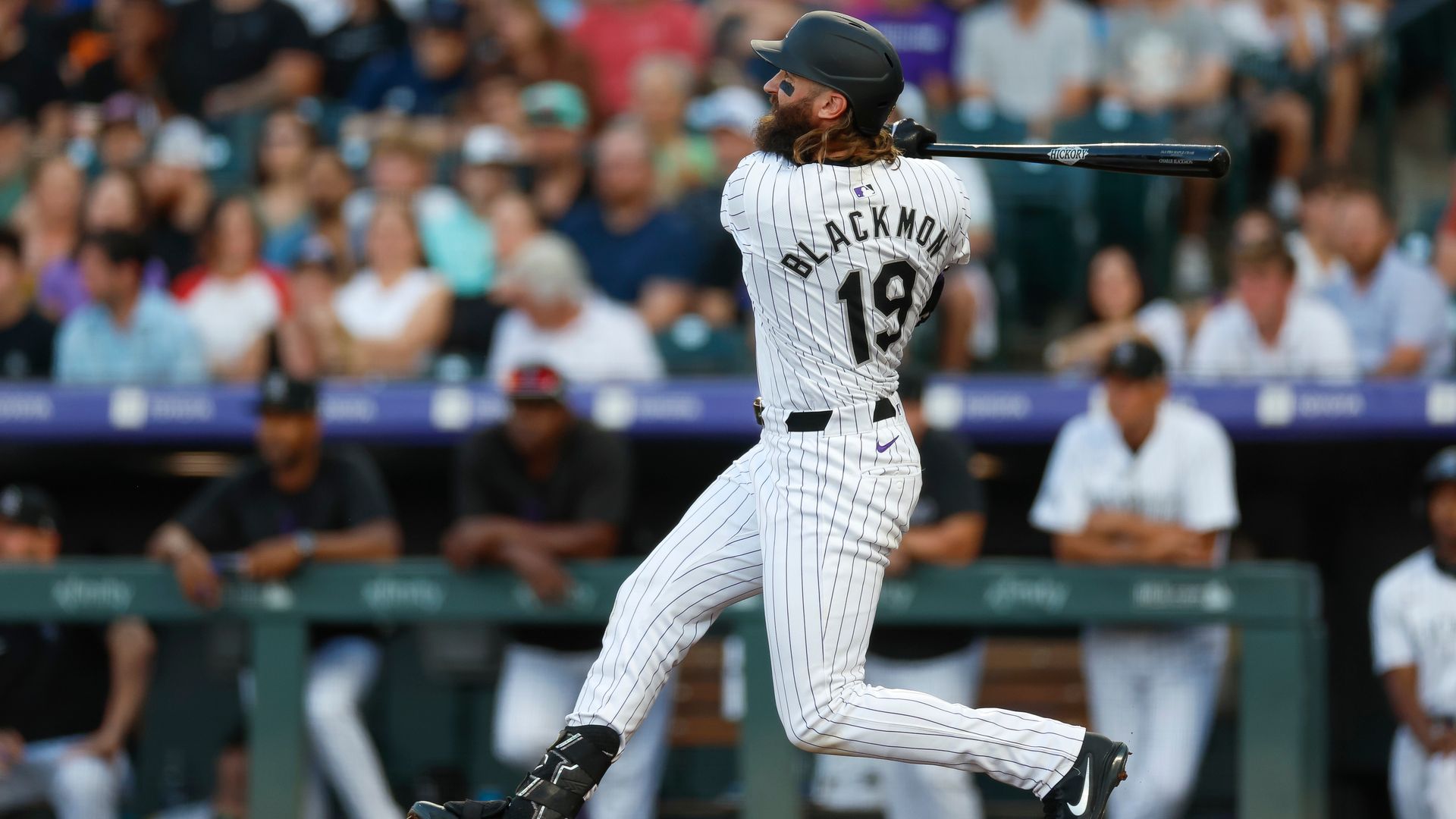 Charlie Blackmon #19 of the Colorado Rockies hits a two-run home run in the second inning during a game against the San Diego Padres at Coors Field on August 16, 2024 in Denver, Colorado. 