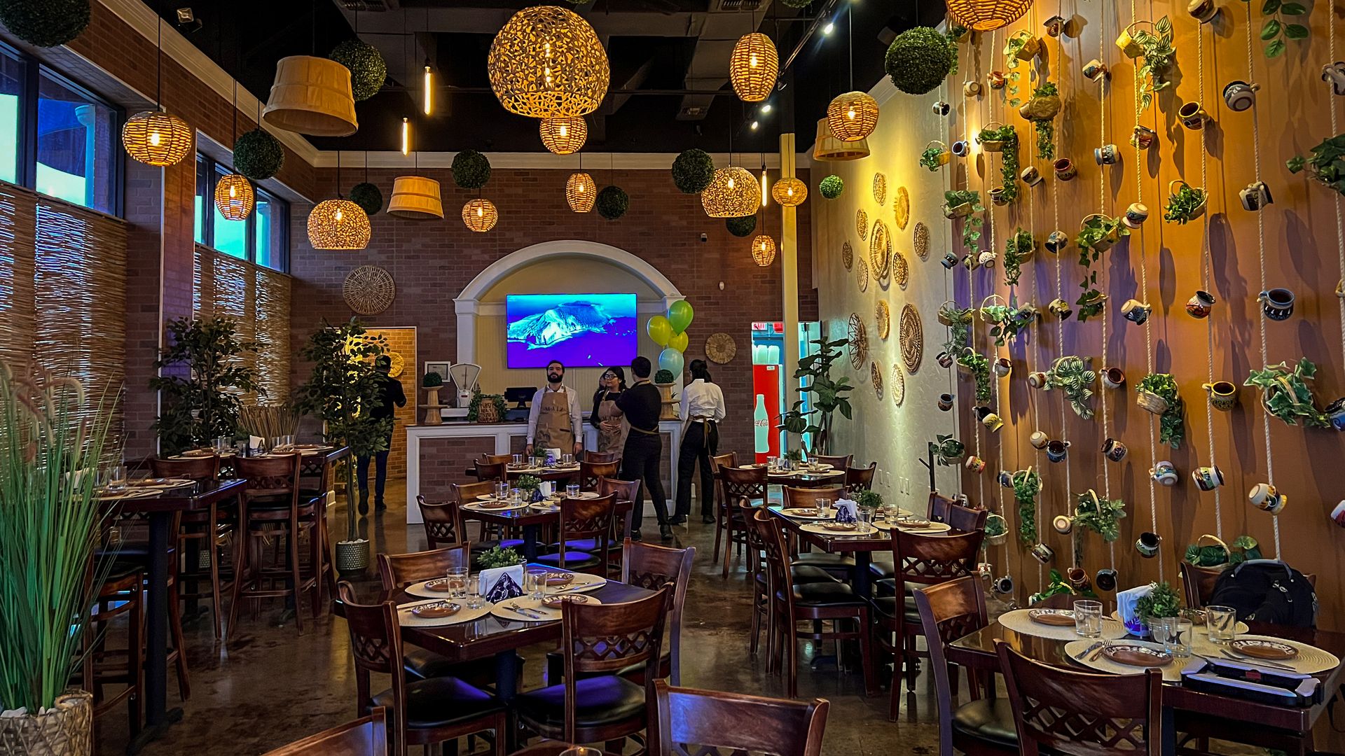 An intimate dining room with low-lit light fixtures and wall decor.