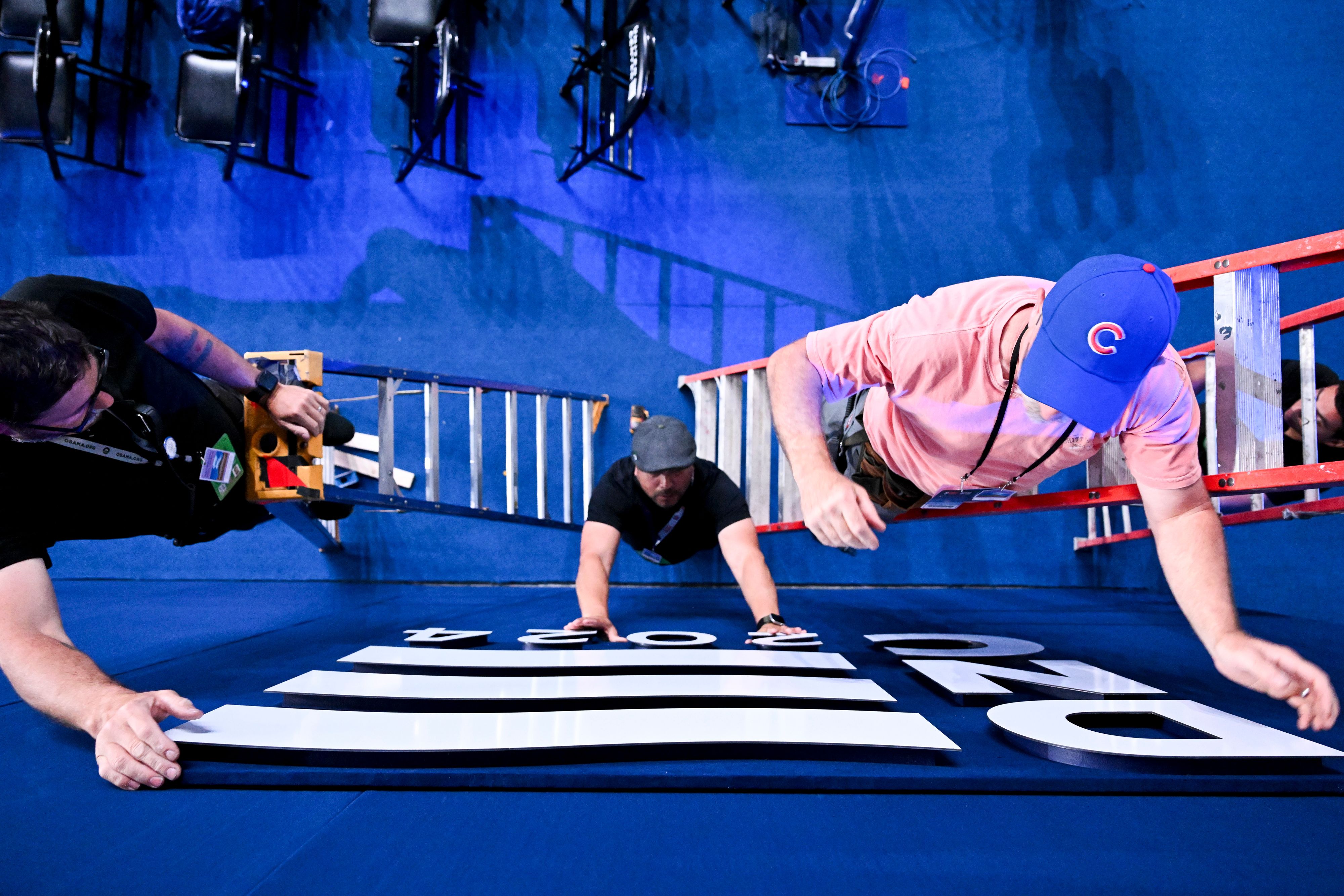 Workers add finishing touches for the DNC at the United Center yesterday.