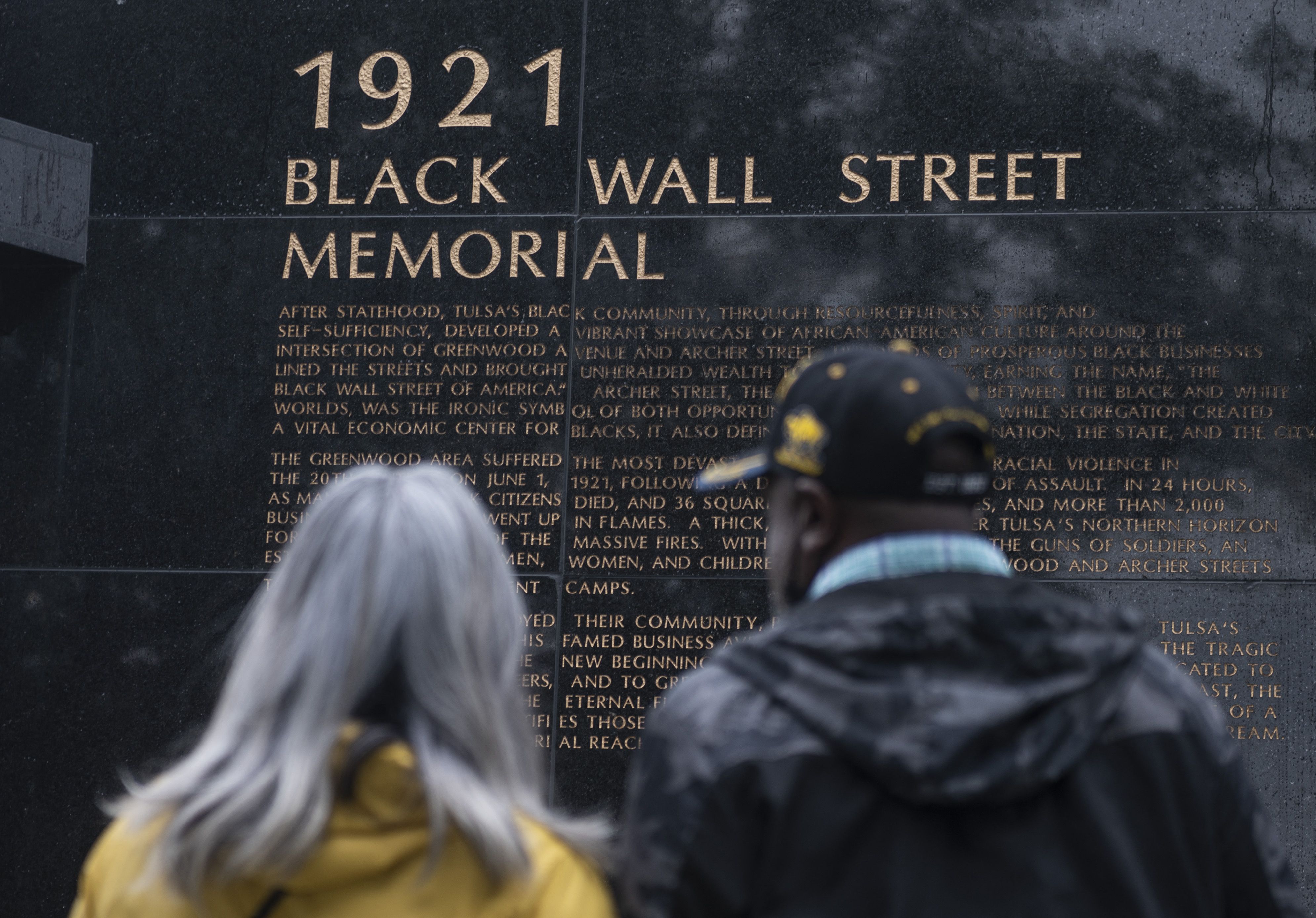 People look at the 1921 Black Wall Street Memorial on the 100 year anniversary of the Greenwood massacre in Tulsa, Oklahoma, on May 31