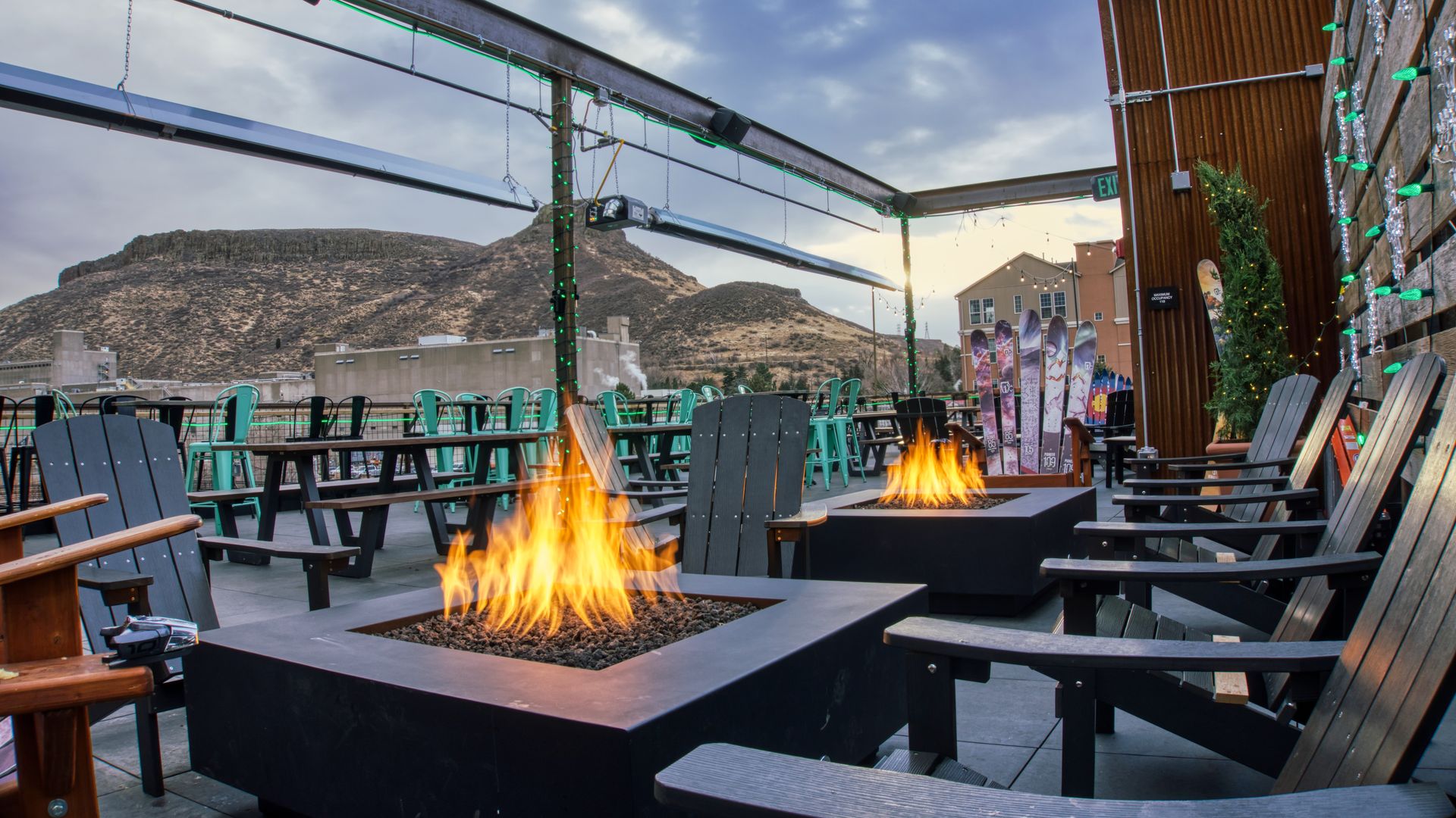 Firepits on a rooftop in front of the mountains