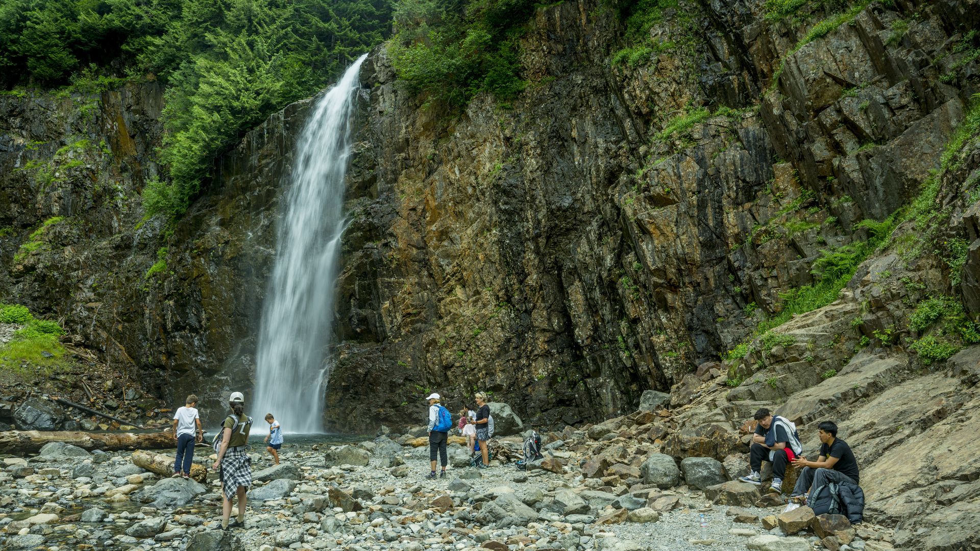 People at Franklin Falls, a waterfall on the South fork of the Snoqualmie River in the Mt. Baker-Snoqualmie National Forest near Snoqualmie Pass, King County, Washington State, USA.