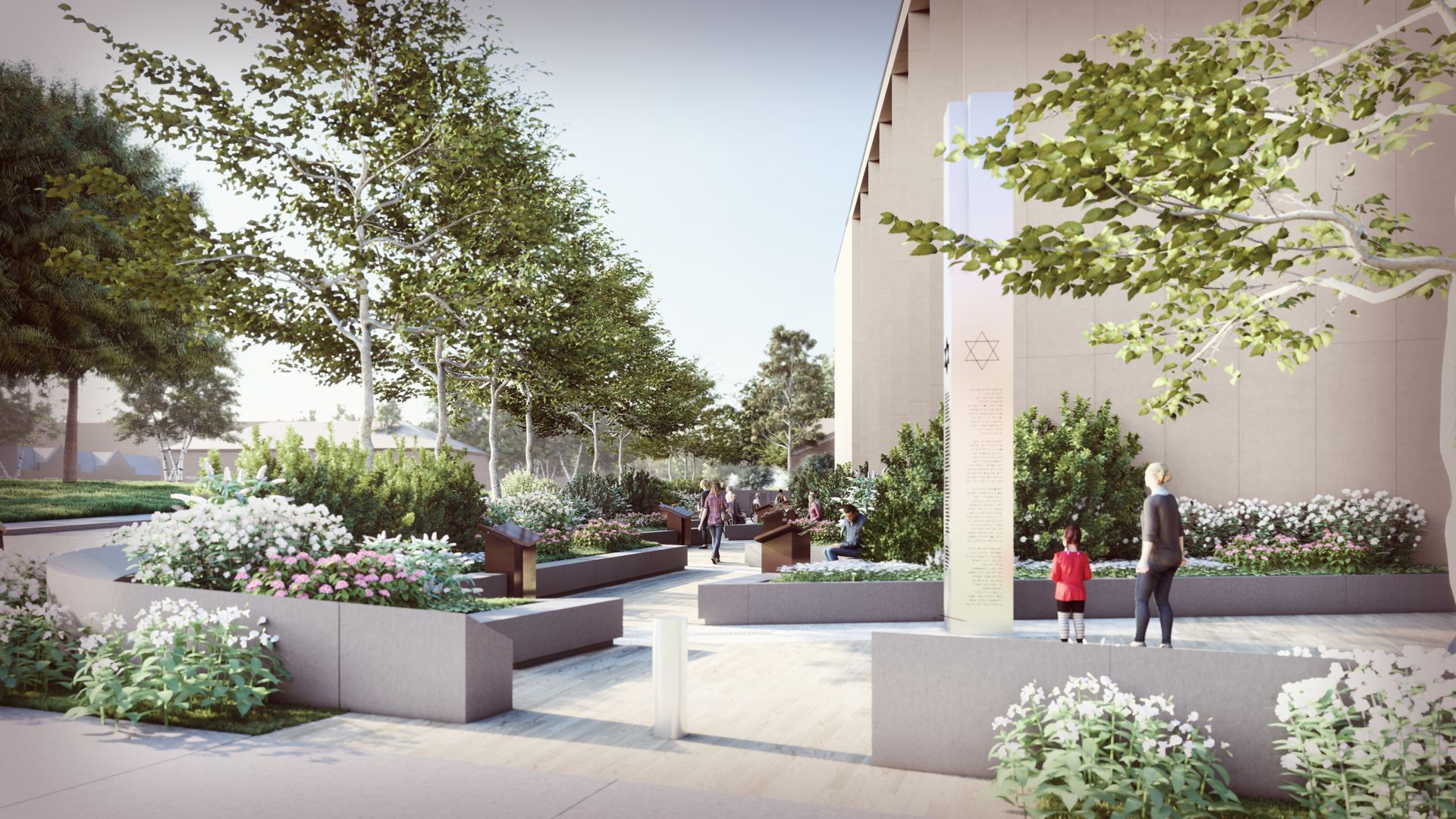 A serene courtyard beside a beige building, with green trees, flower beds, and concrete benches. People walk along a path toward a tall pillar with a Star of David.