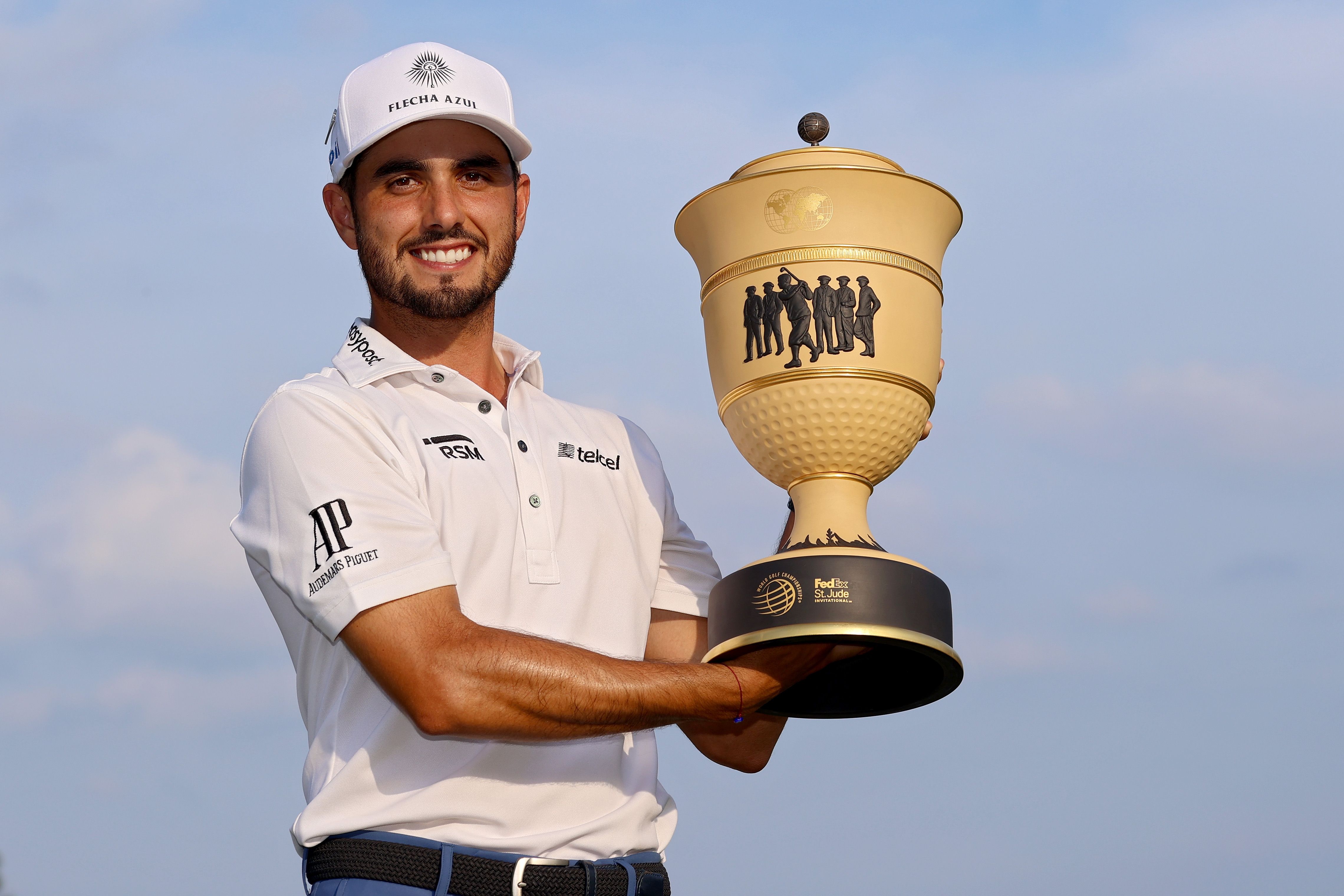 abraham ancer holding golf trophy