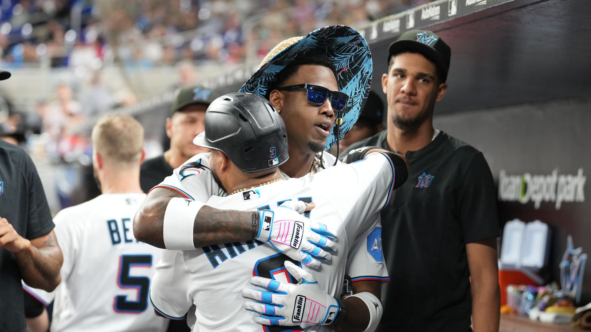 Two baseball players hug.