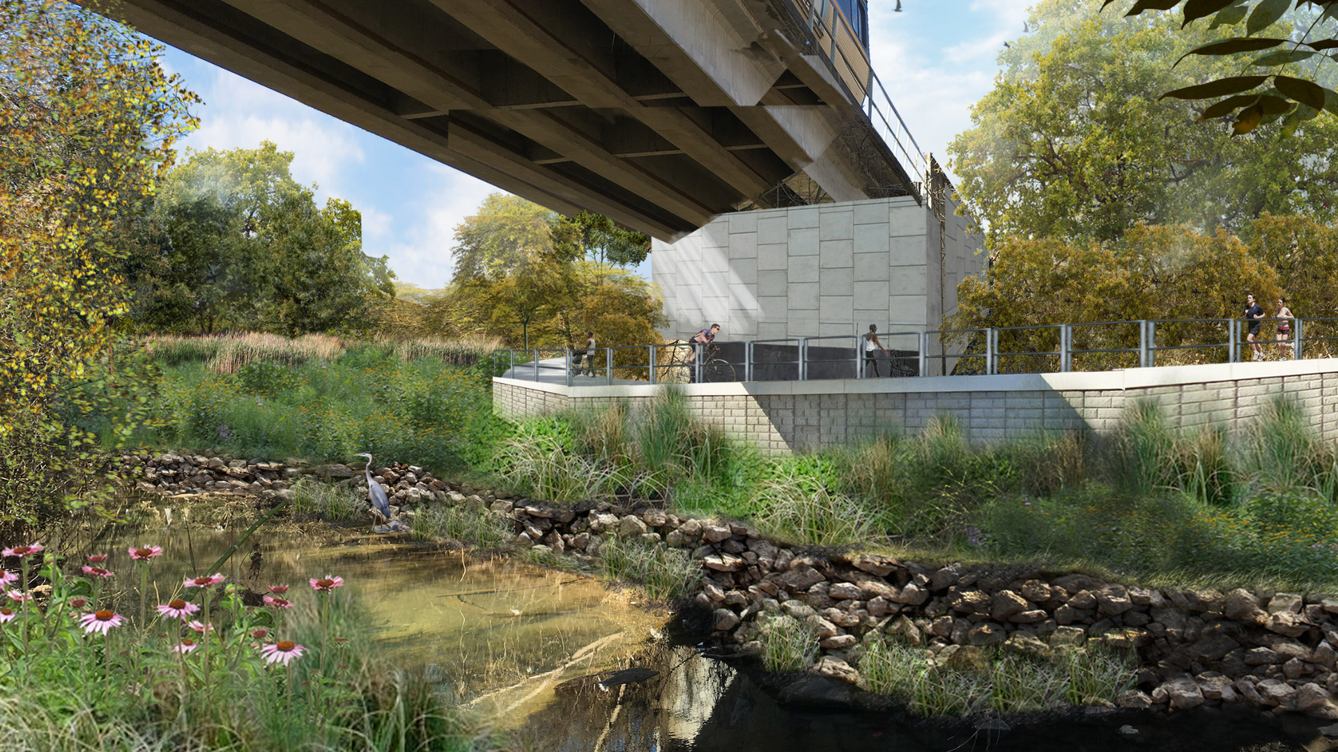 A bicyclist and jogger use a trail along a waterway passing under a rail line.