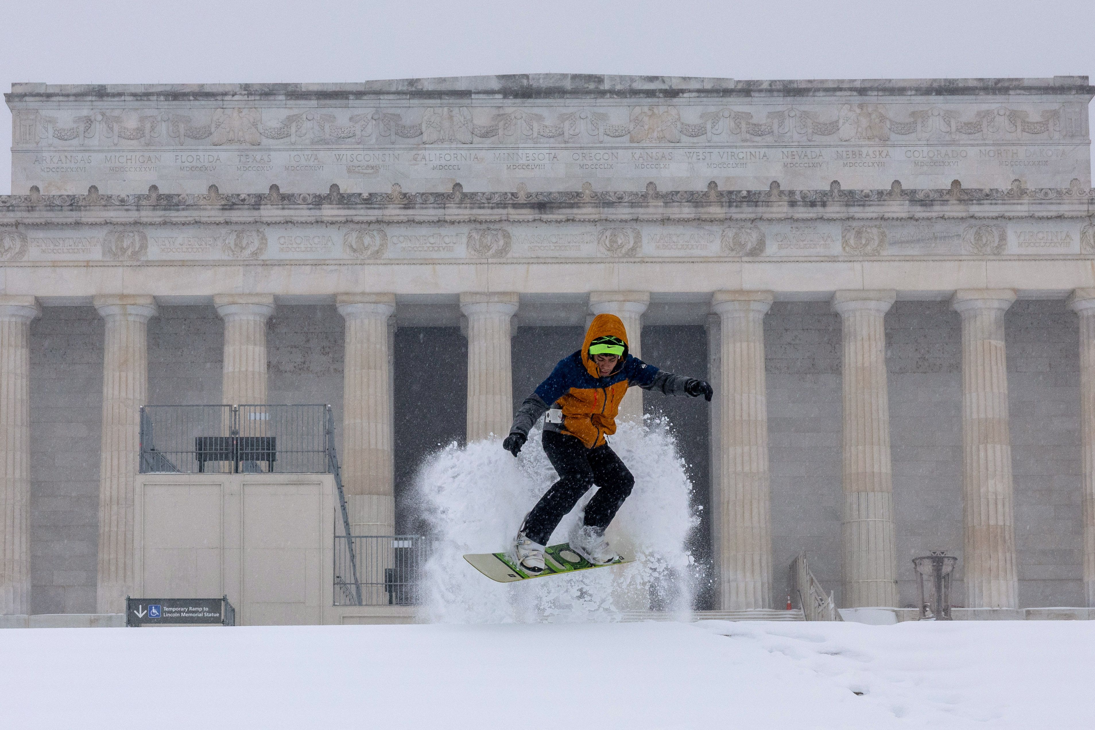 A man snowboards on stairs near the Lincoln Memorial yesterday. 