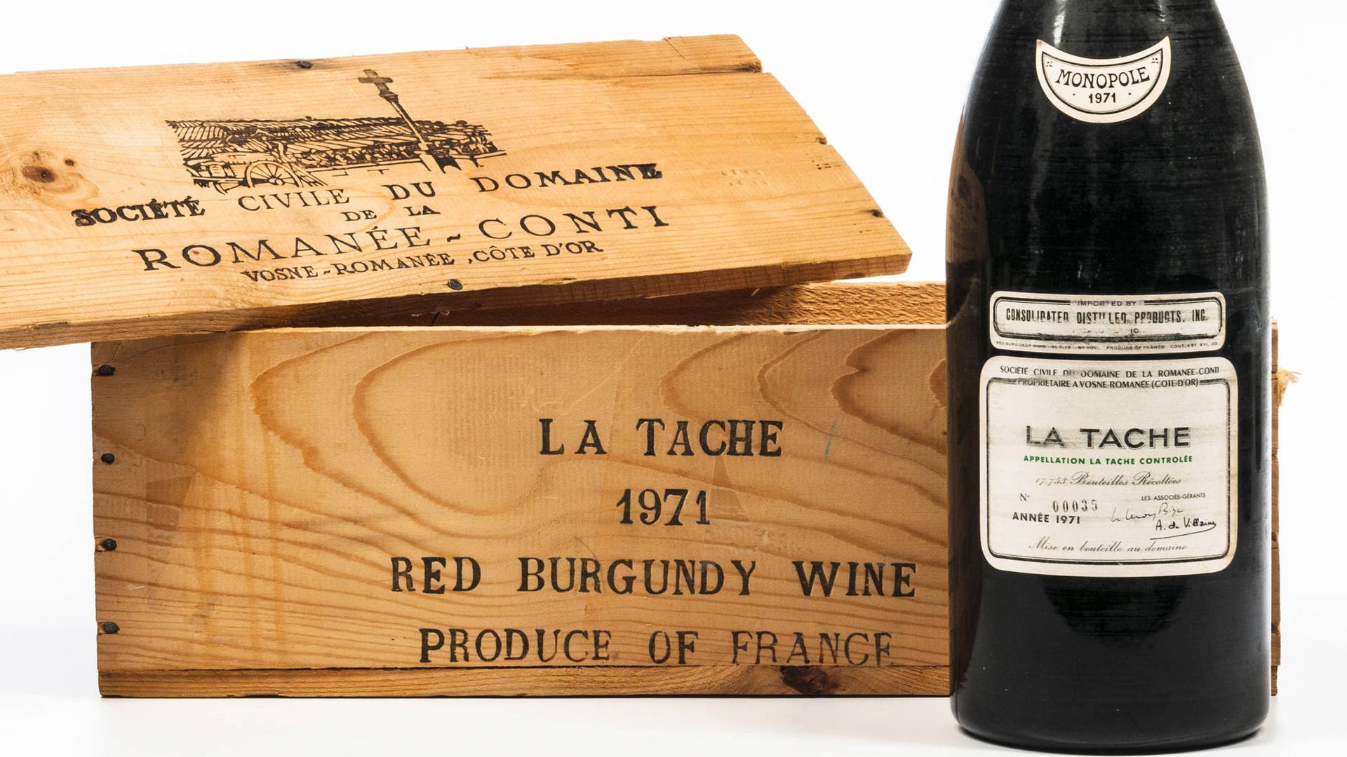 A dark, green-tinted, 3-liter bottle of rare French wine is next to a box that says "La Tache 1971 Red Burgundy Wine"