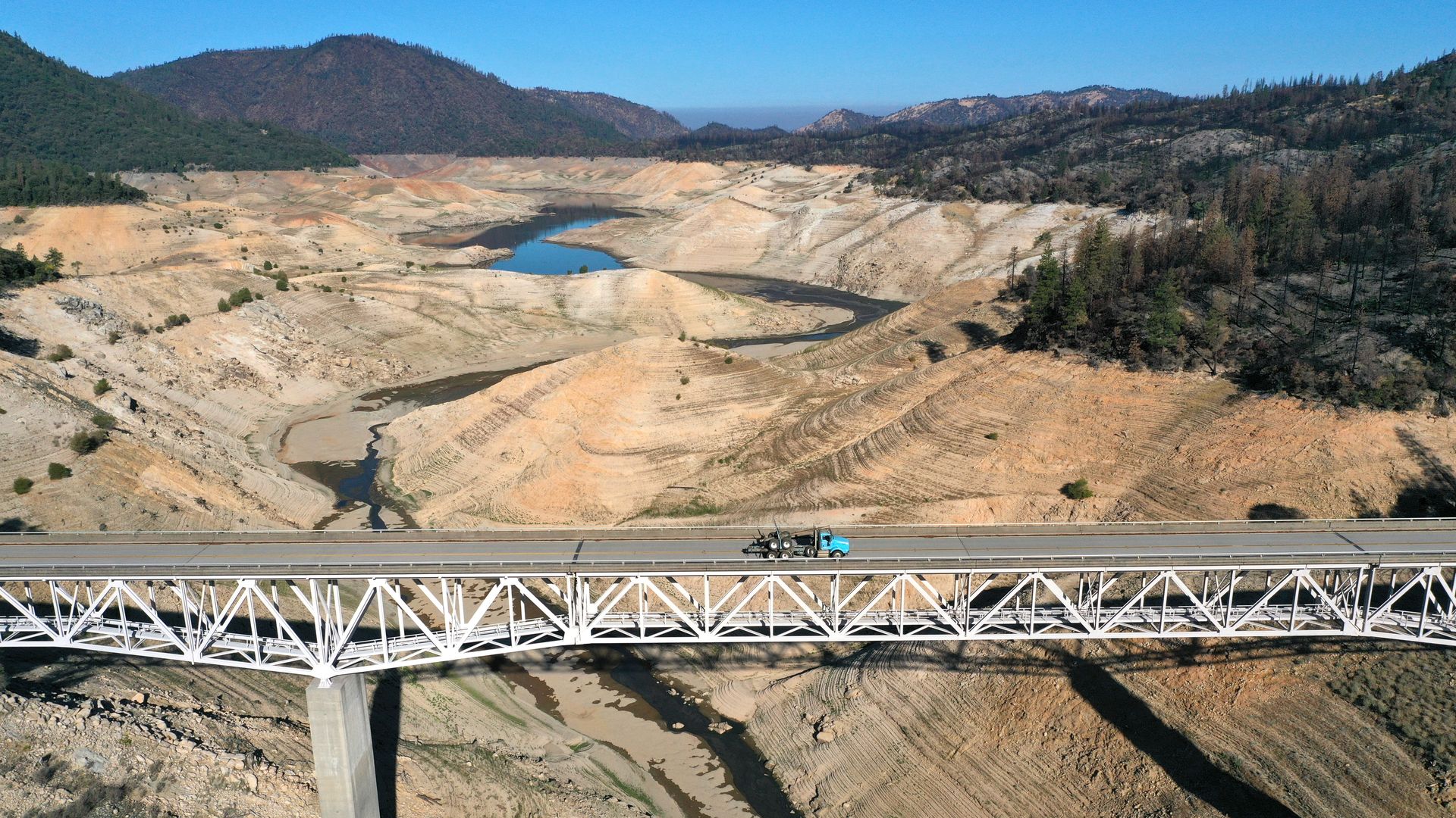 In an aerial view, the Enterprise Bridge crosses over a section of Lake Oroville that was previously underwater on July 22, 2021 in Oroville, California.
