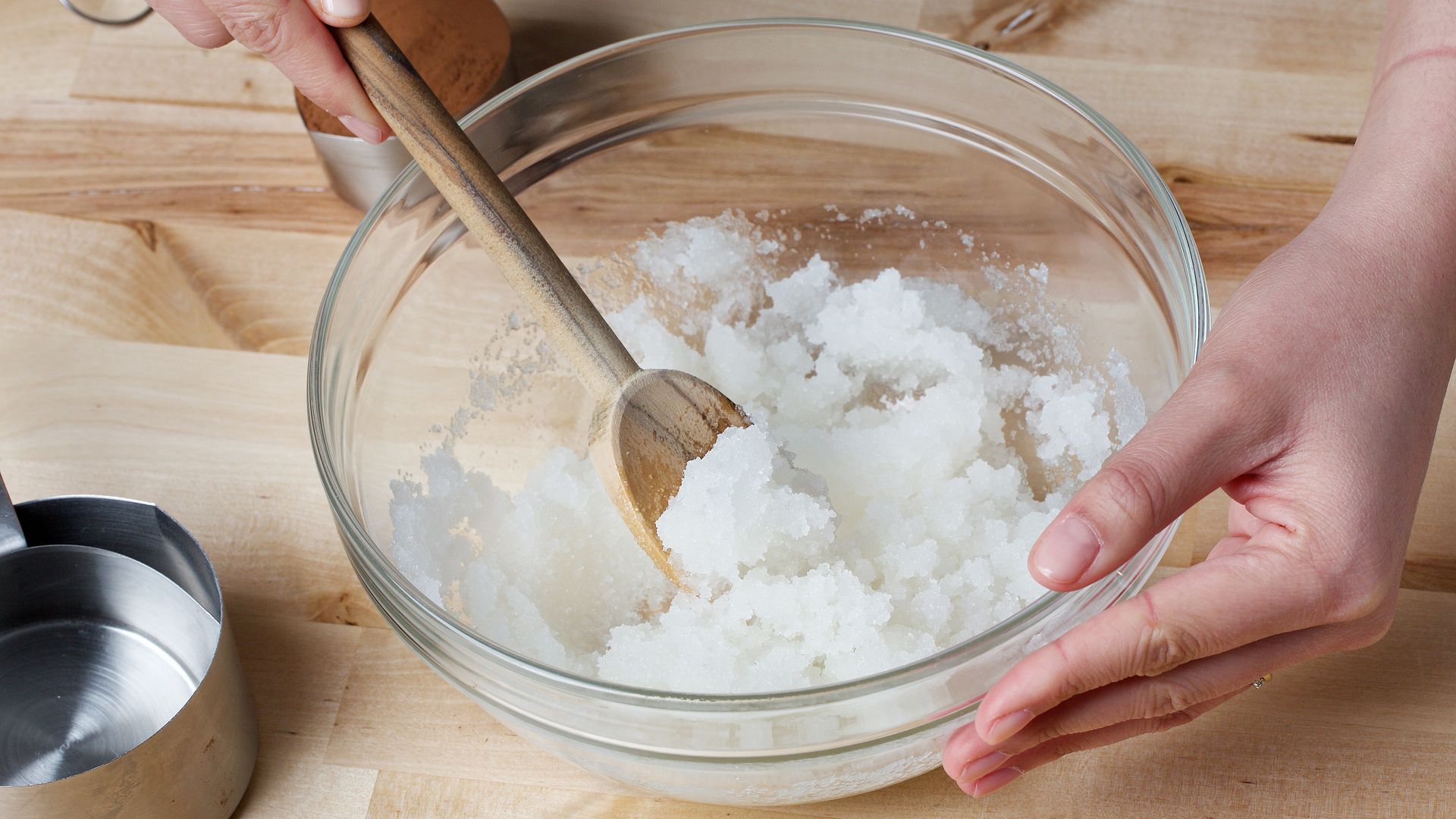 Coconut oil being mixed with sugar. 