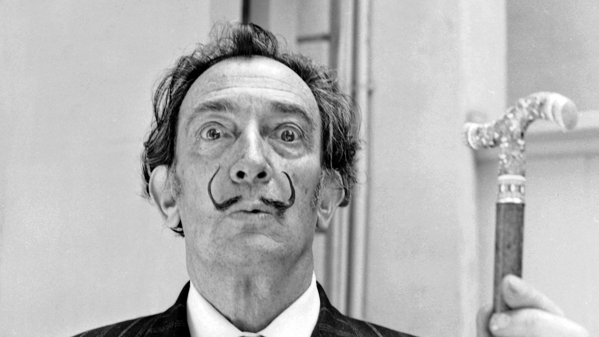 Dali faces the camera with his eyes open wide