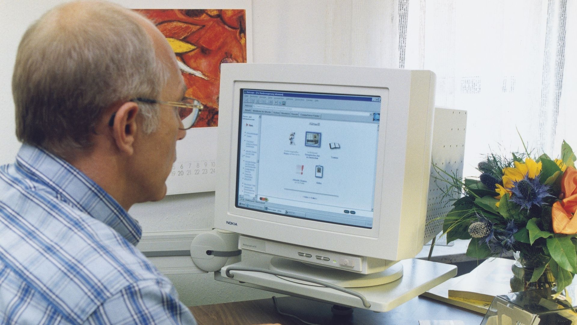 A man uses an old computer