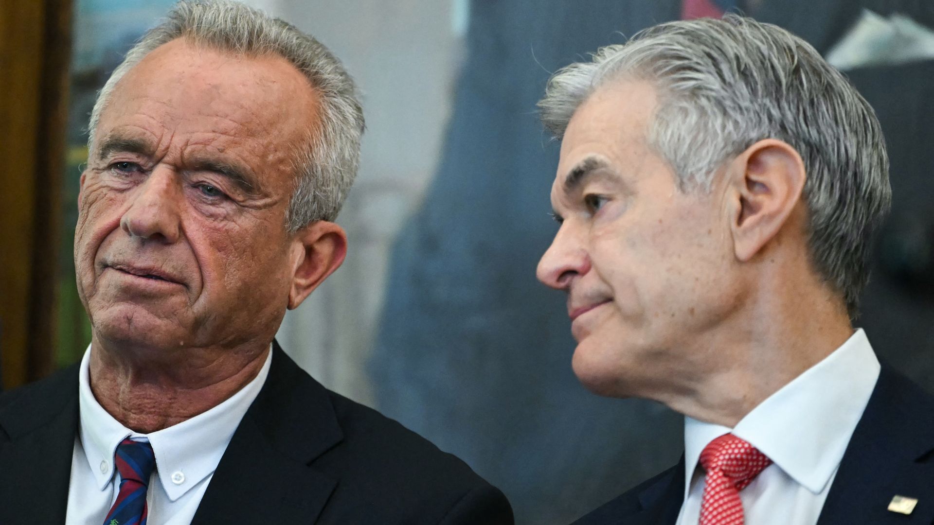 RFK Jr — wearing a dark blazer, a white collared shirt and a tie — stands next to Dr. Oz — also wearing a dark blazer, a white collared shirt and a tie — during a White House event.