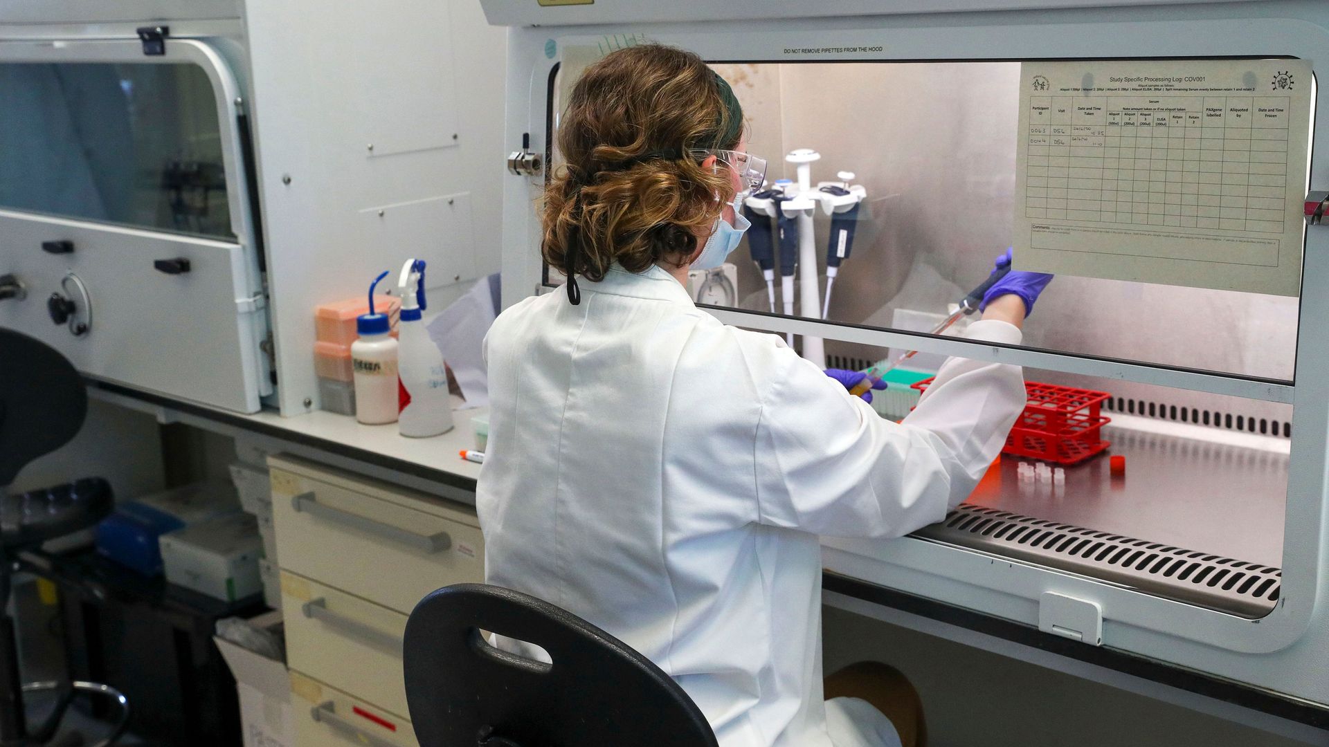 A scientist is pictured working at the Oxford Vaccine Group's laboratory facility at the Churchill Hospital in Oxford, west of London on June 24