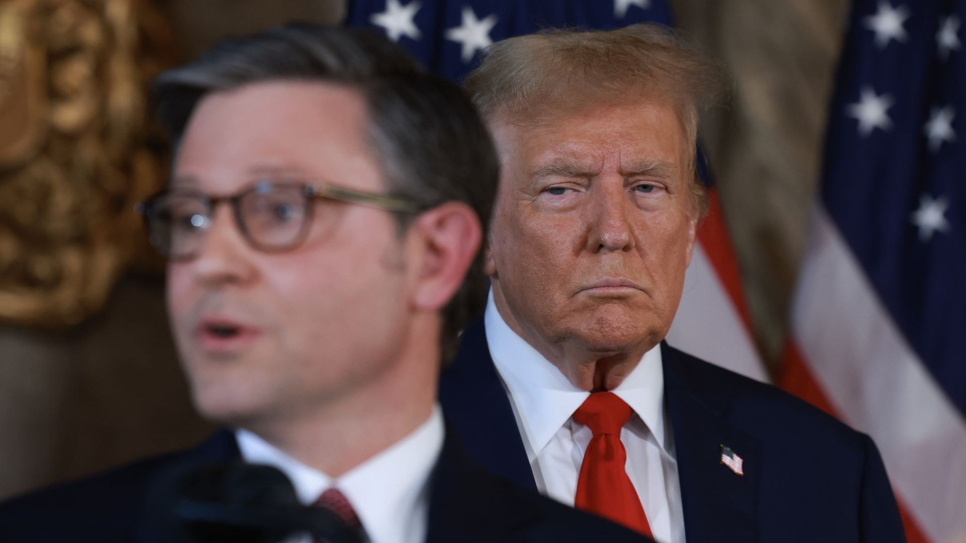 Trump behind johnson glowering