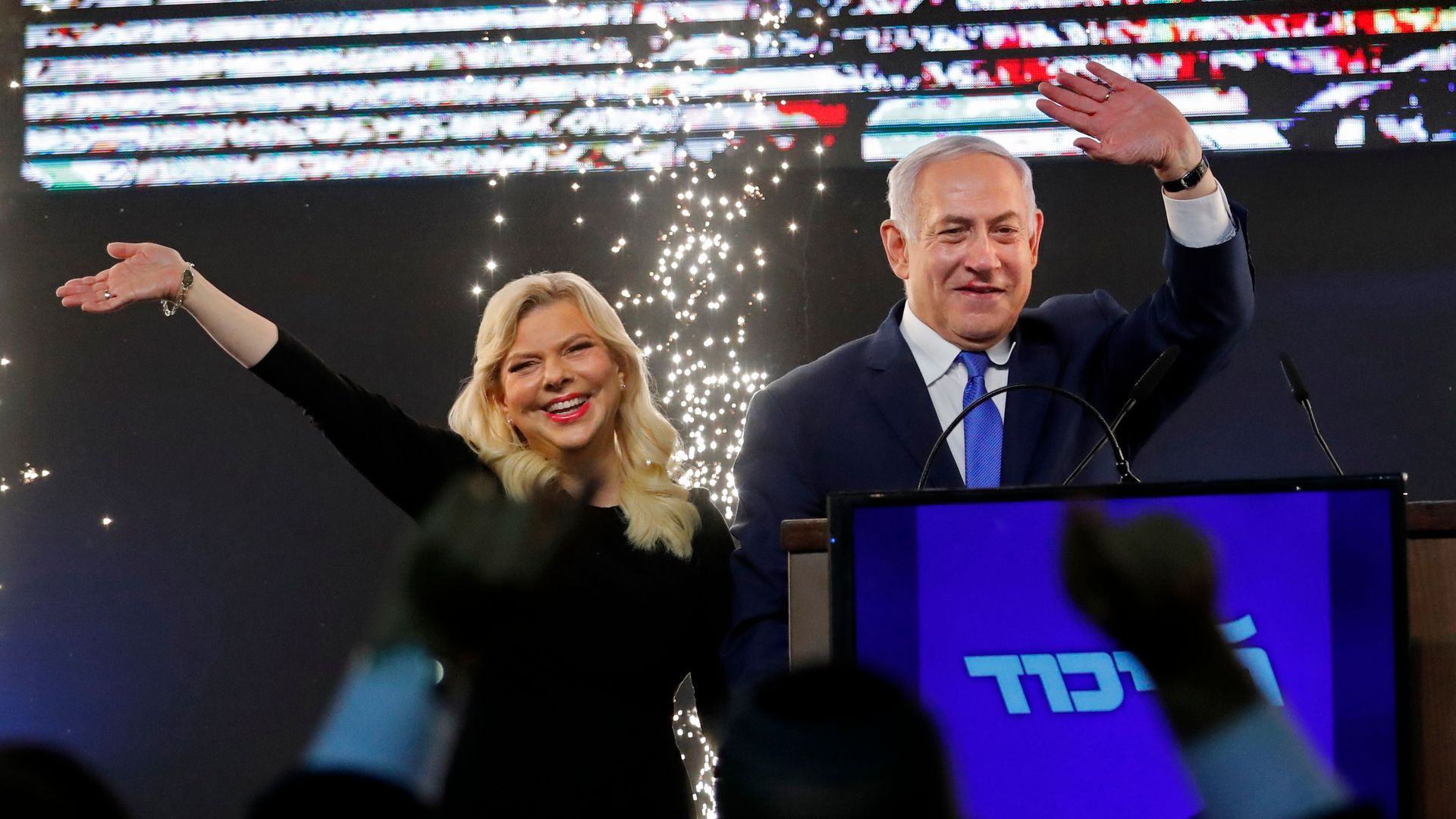 Benjamin Netanyahu and his wife, Sara, on stage before supporters