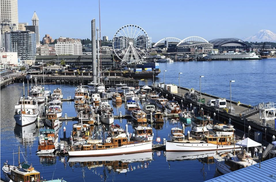 Dozens of wooden yachts at a pier on Seattle's waterfront.
