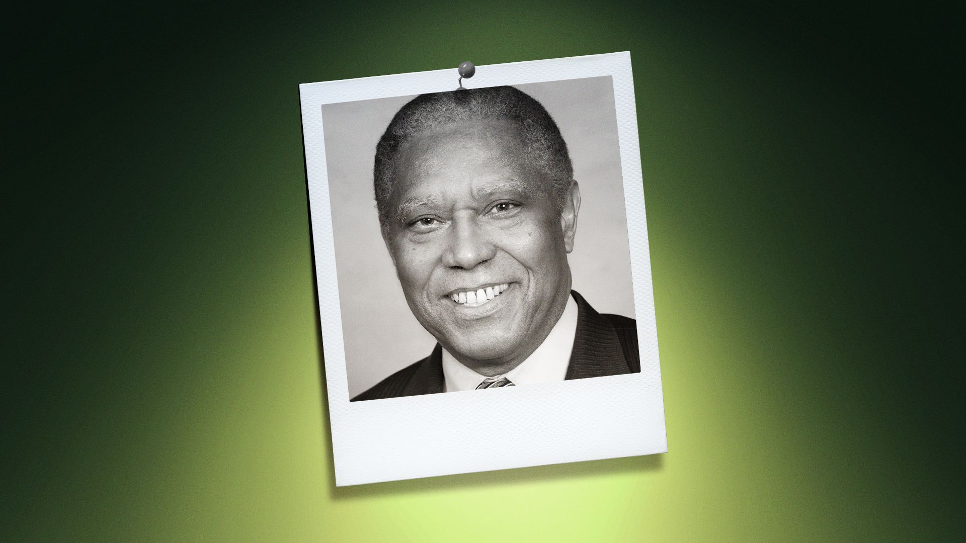 Photo illustration of Dan Blue in the center of a Polaroid photo under a green spotlight.