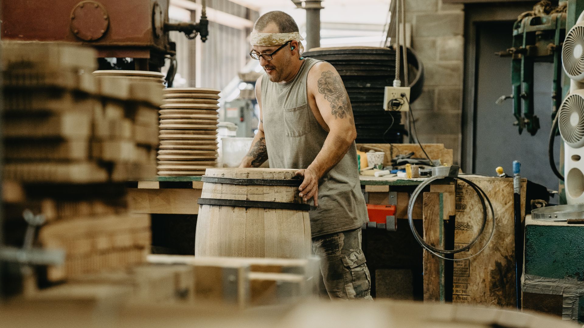 A man holds a barrel.