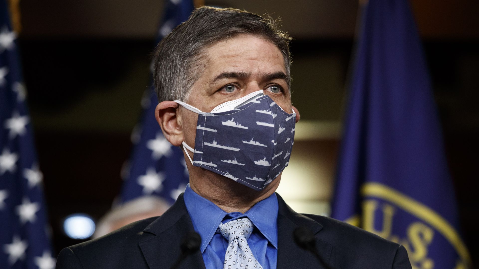Rep, Filemon Vela is seen wearing a COVID mask as he participates in a news conference.