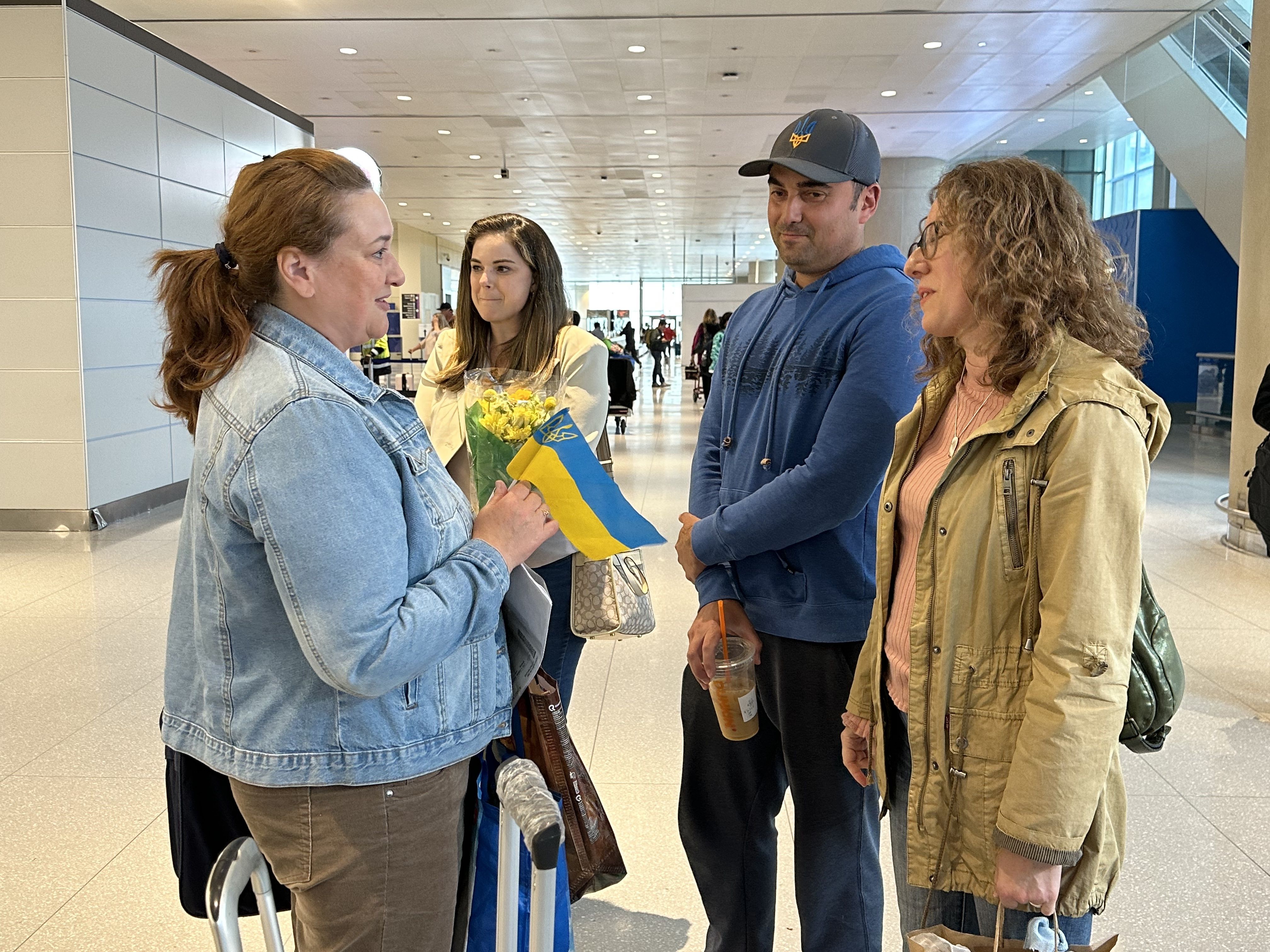 Alina Chernyakova, a Ukrainian refugee, speaks to two volunteers she met virtually before coming to Boston. The voluneers are members of Temple Beth Shalom in Needham, where Alina will work as a teacher.