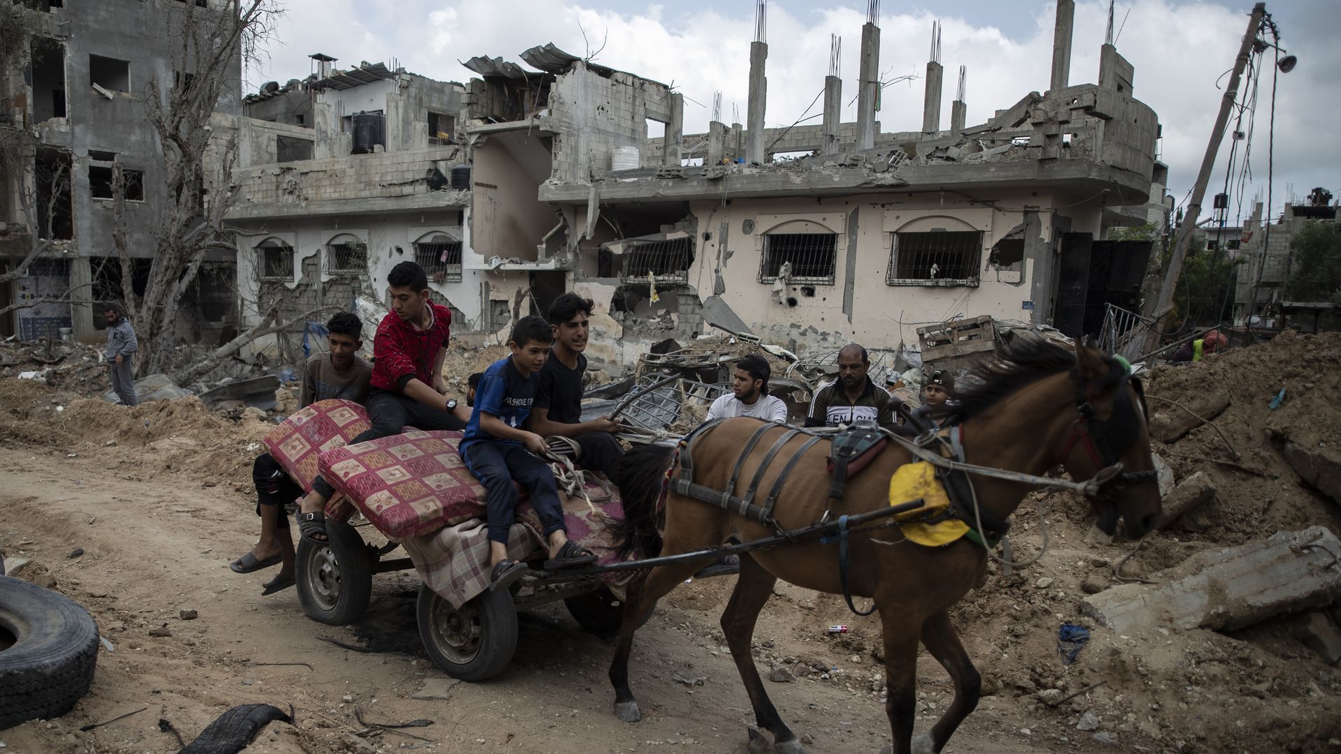 On a horse cart loaded with belongings, Palestinians return today to their home in the town of Beit Hanoun, northern Gaza Strip