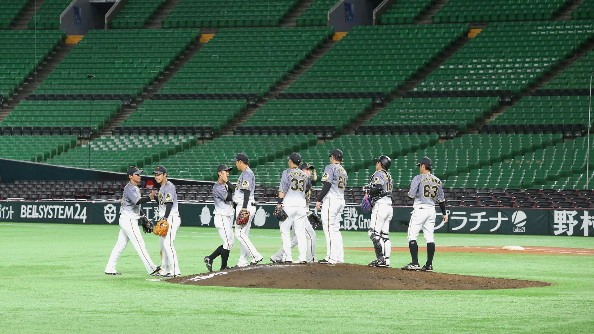 Players celebrate in empty baseball stadium