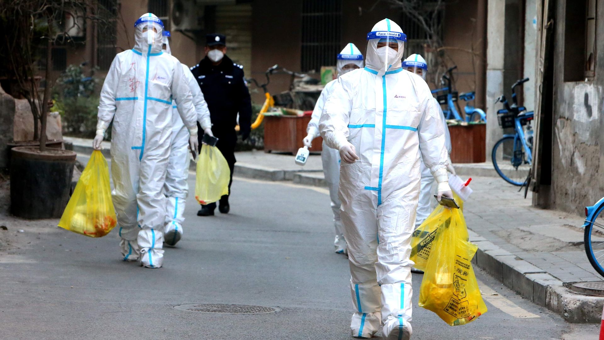 Staff members in protective suits conduct COVID-19 nuclei acid tests in Xi'an, China