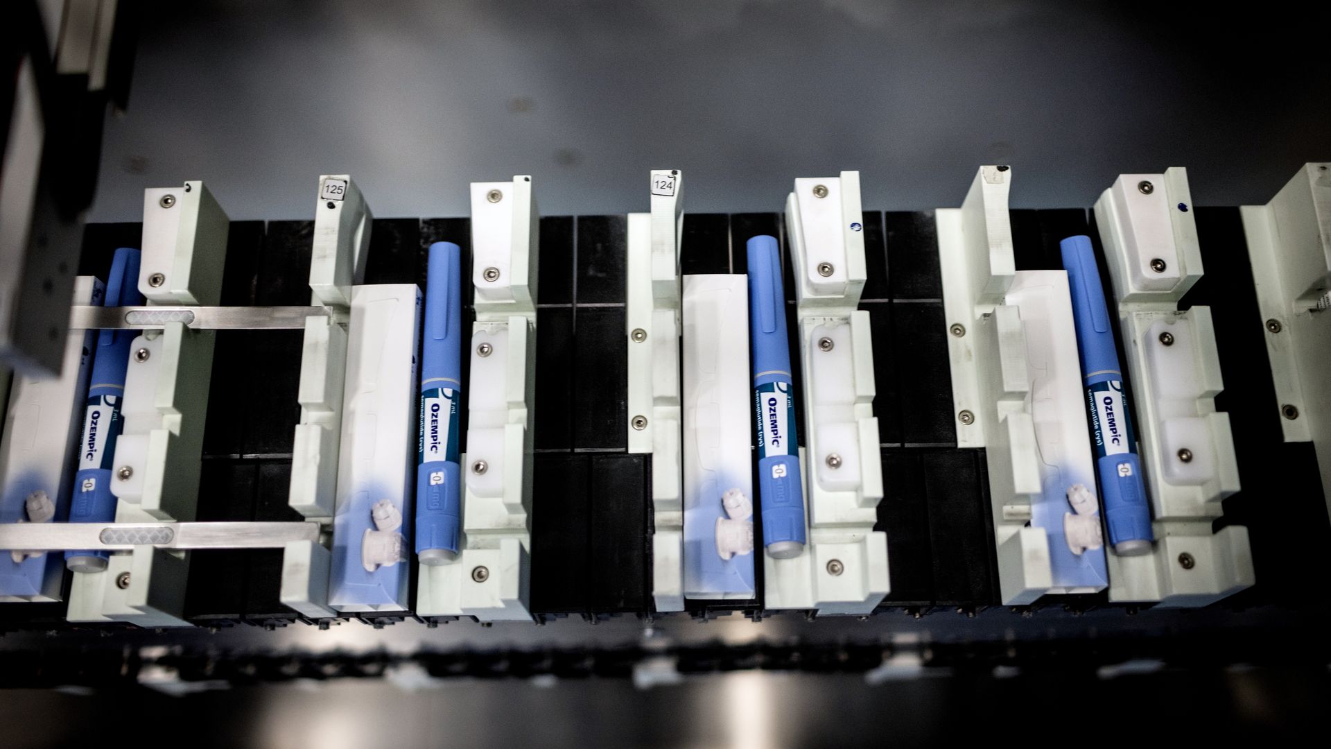 medical Injector pens on a conveyer belt