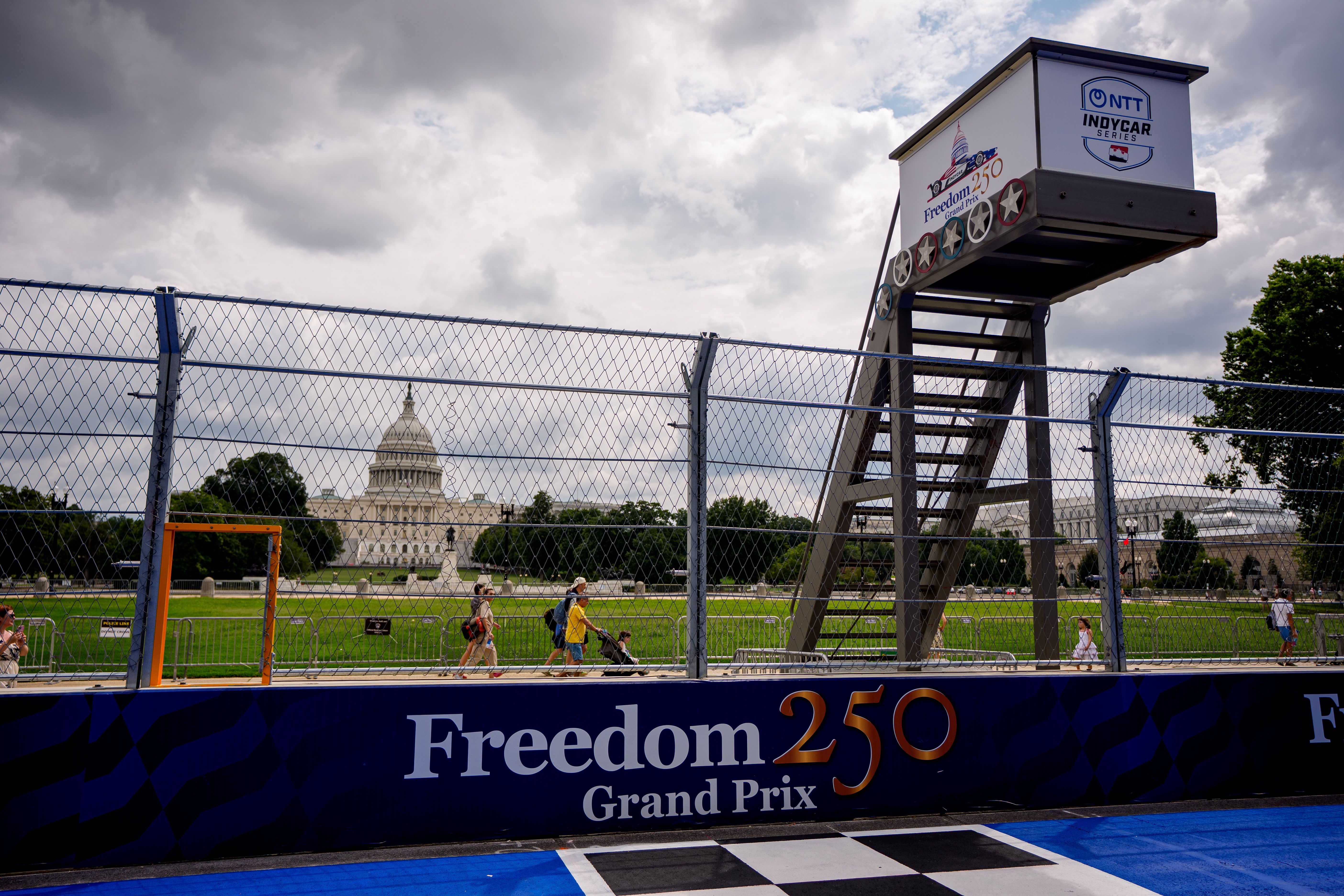 The Capitol can be seen behind a metal fence with Freedom 250 Grand Prix branding