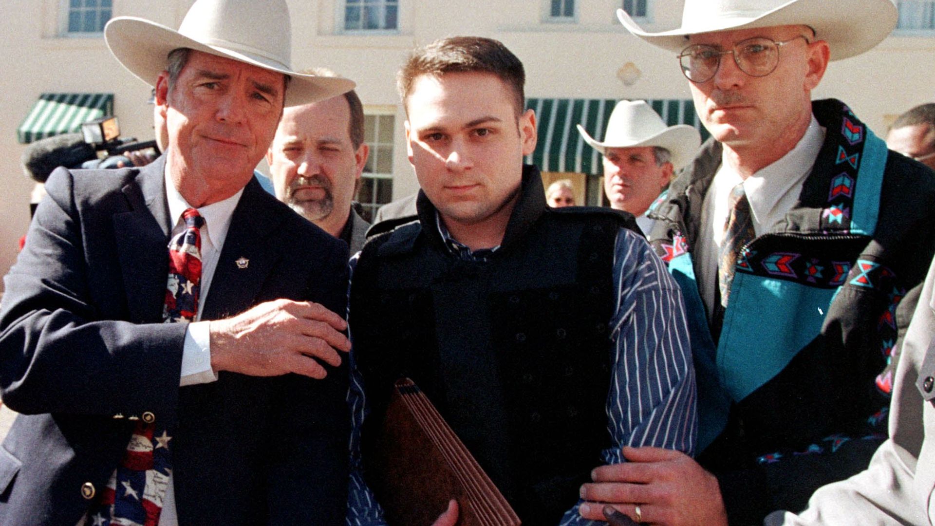 John William "Bill" King (C) is led from the Jasper County Courthouse by unidentified deputies following the first day of jury selection in his murder trial 25 January in Jasper, Texas