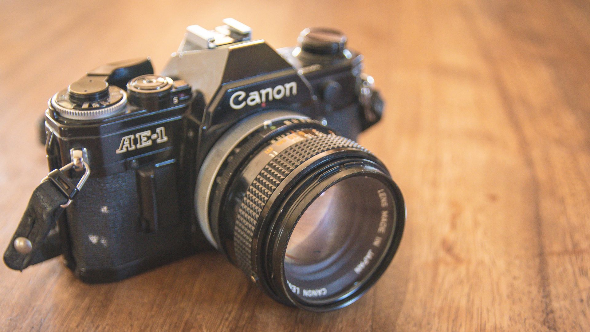 AA displayed Canon AE-1 35mm film camera.