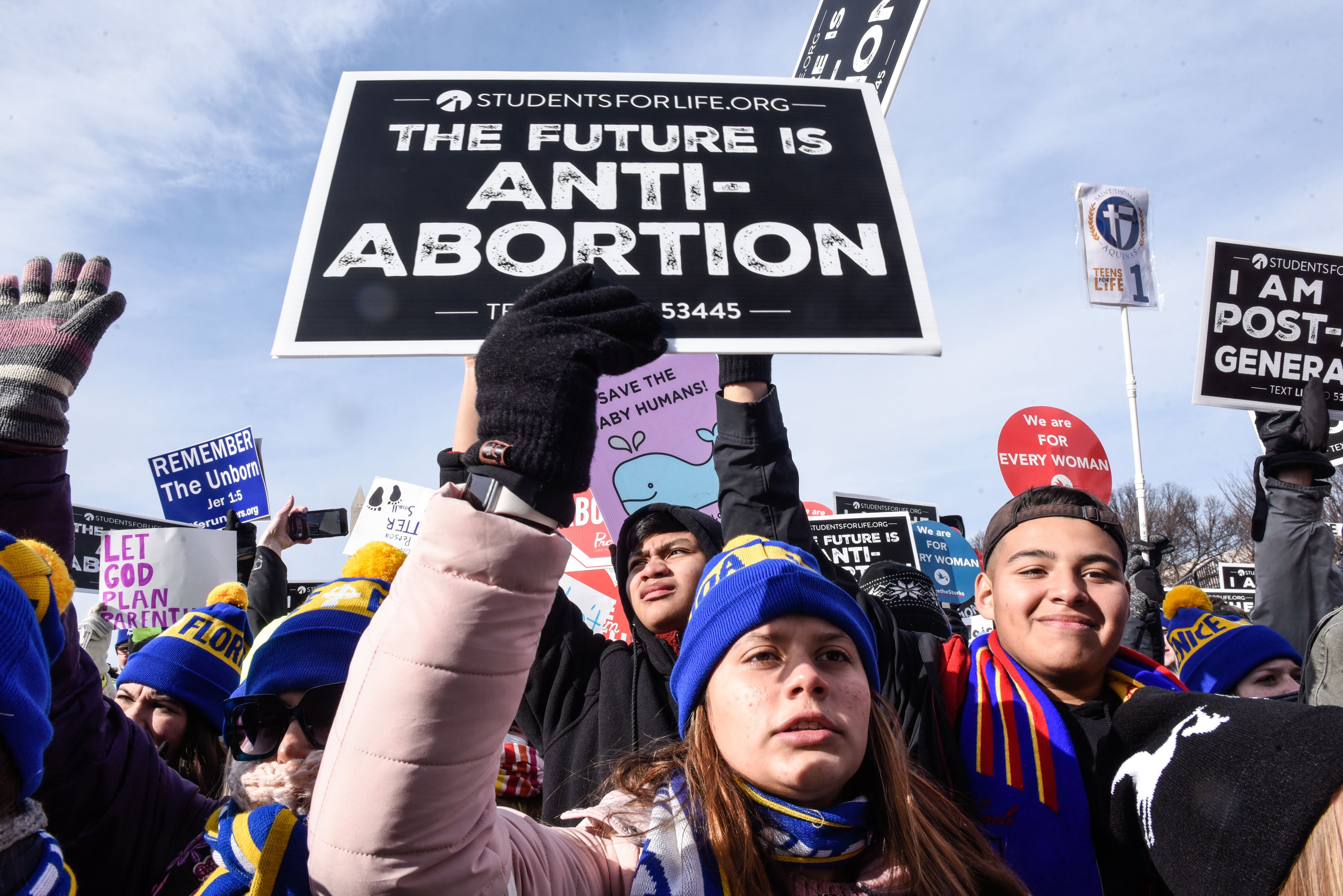 Photo of student protesters holding up signs that say "The future is anti-abortion"