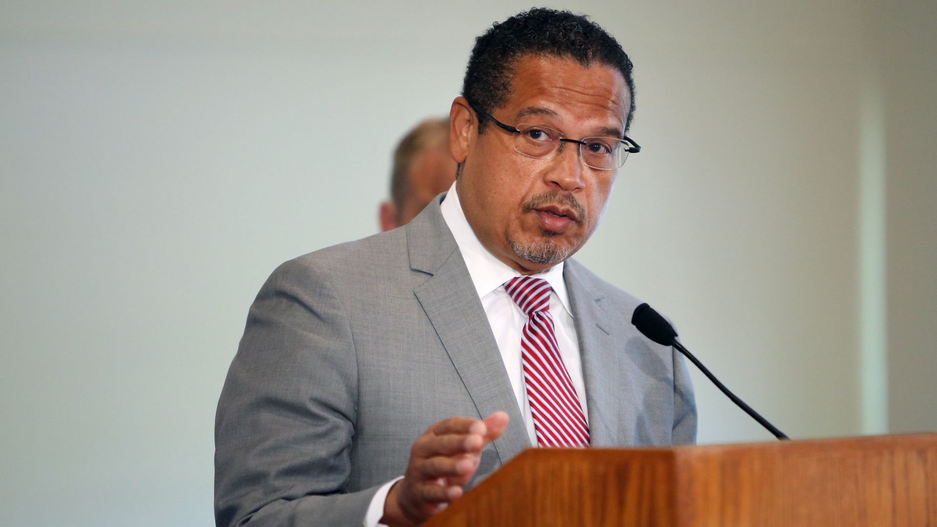A photo of Minnesota Attorney General Keith Ellison speaking at a podium.