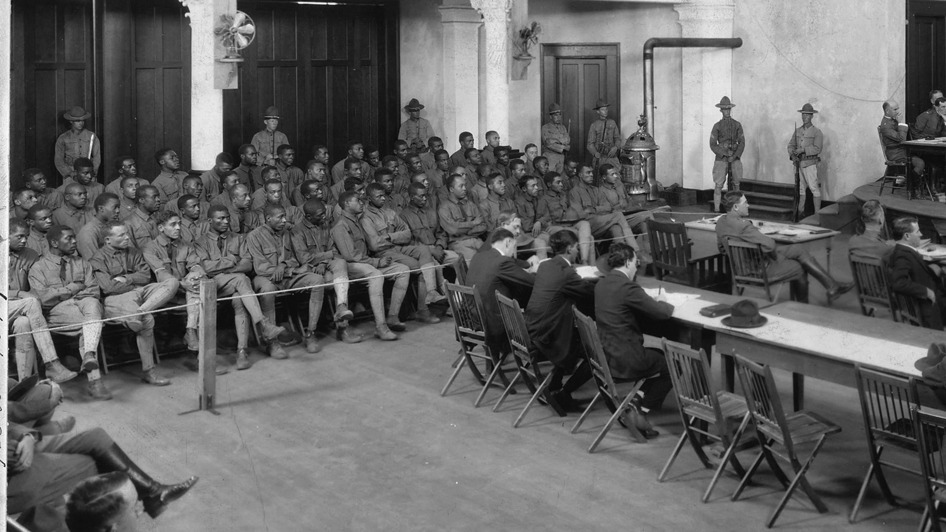 Dozens of Black soldiers sit trial in this black and white photo