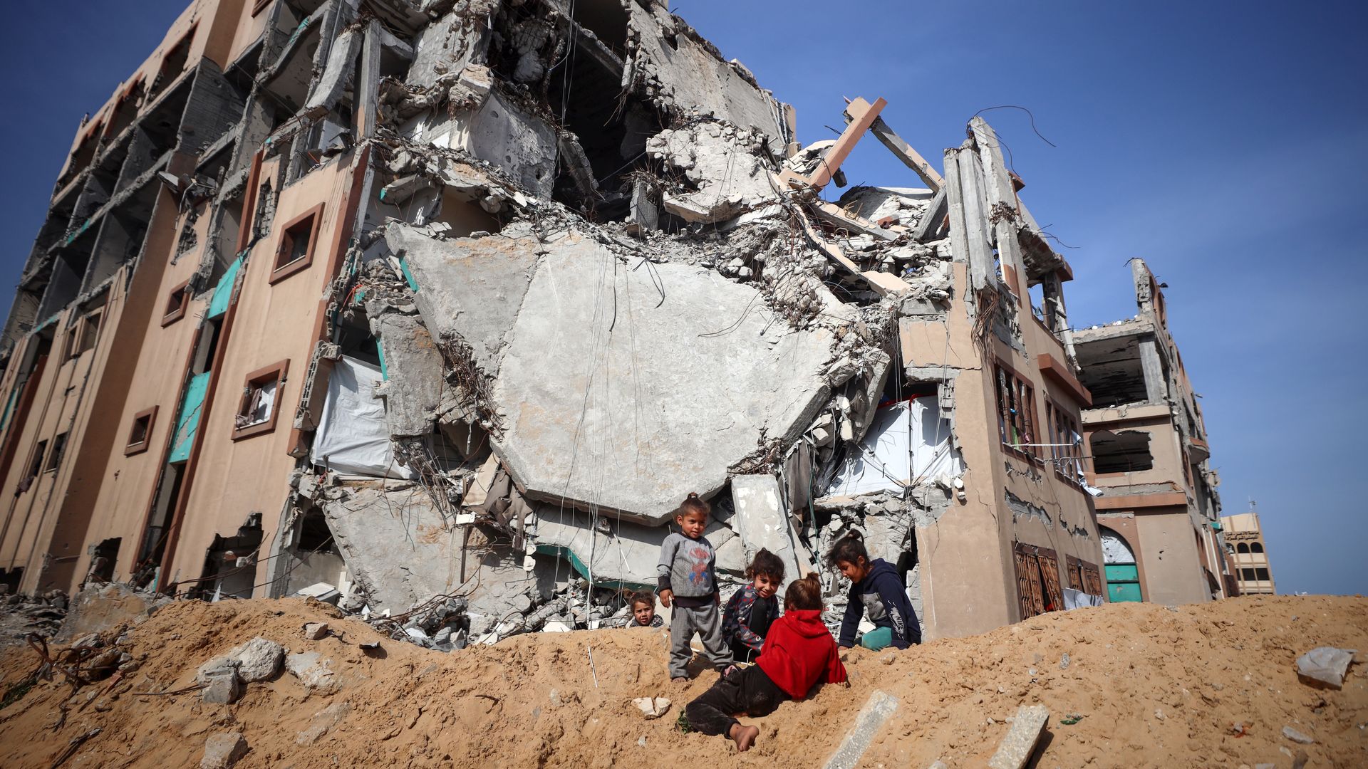 Displaced Palestinian children are seen inside the destroyed Islamic University in Gaza City, Gaza, on March 25, 2025.