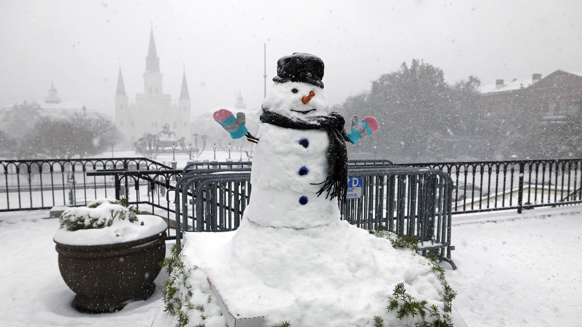 A snowman sits in front of the St. Louis Cathedral.