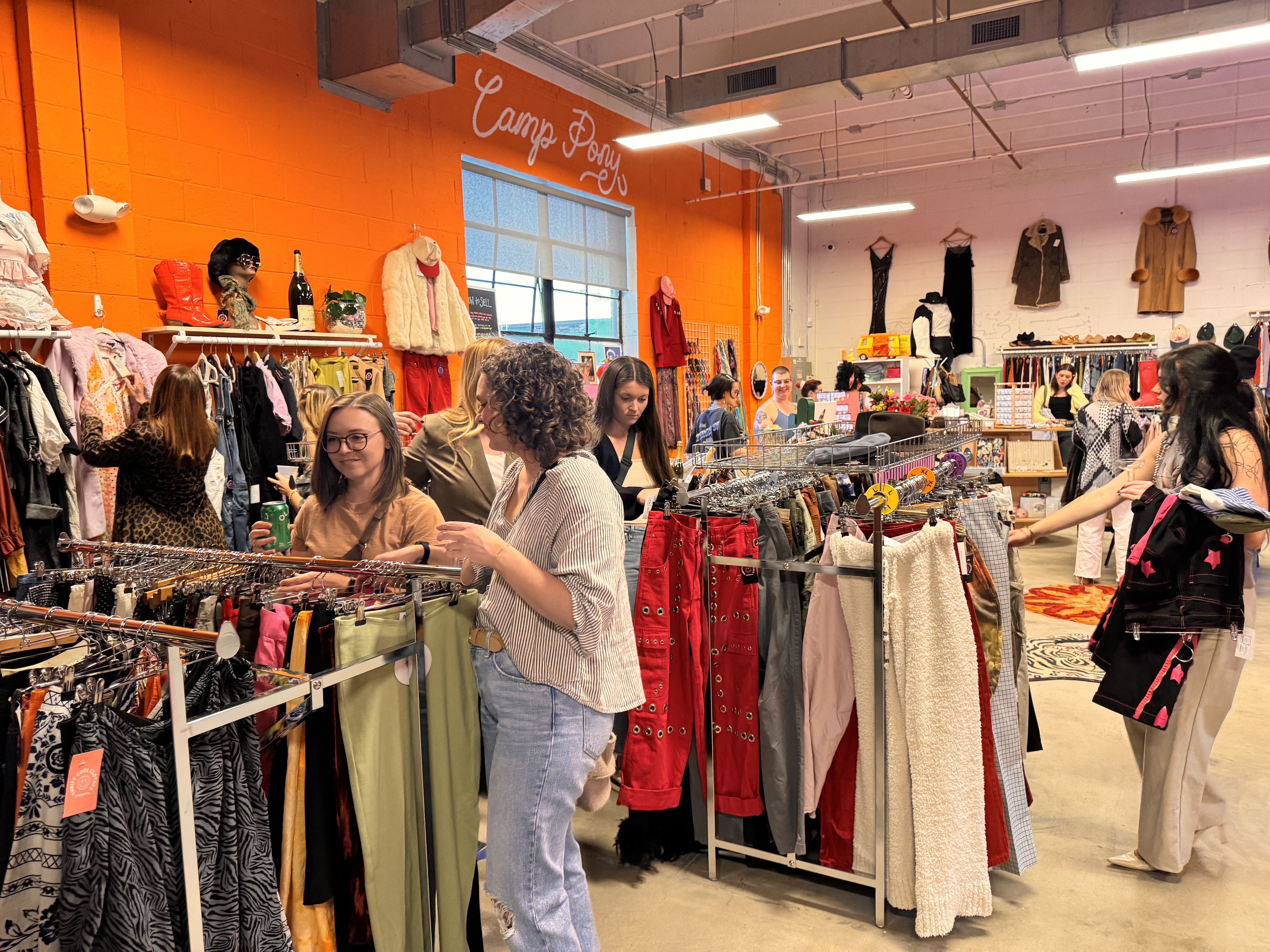 people looking through clothing racks inside store
